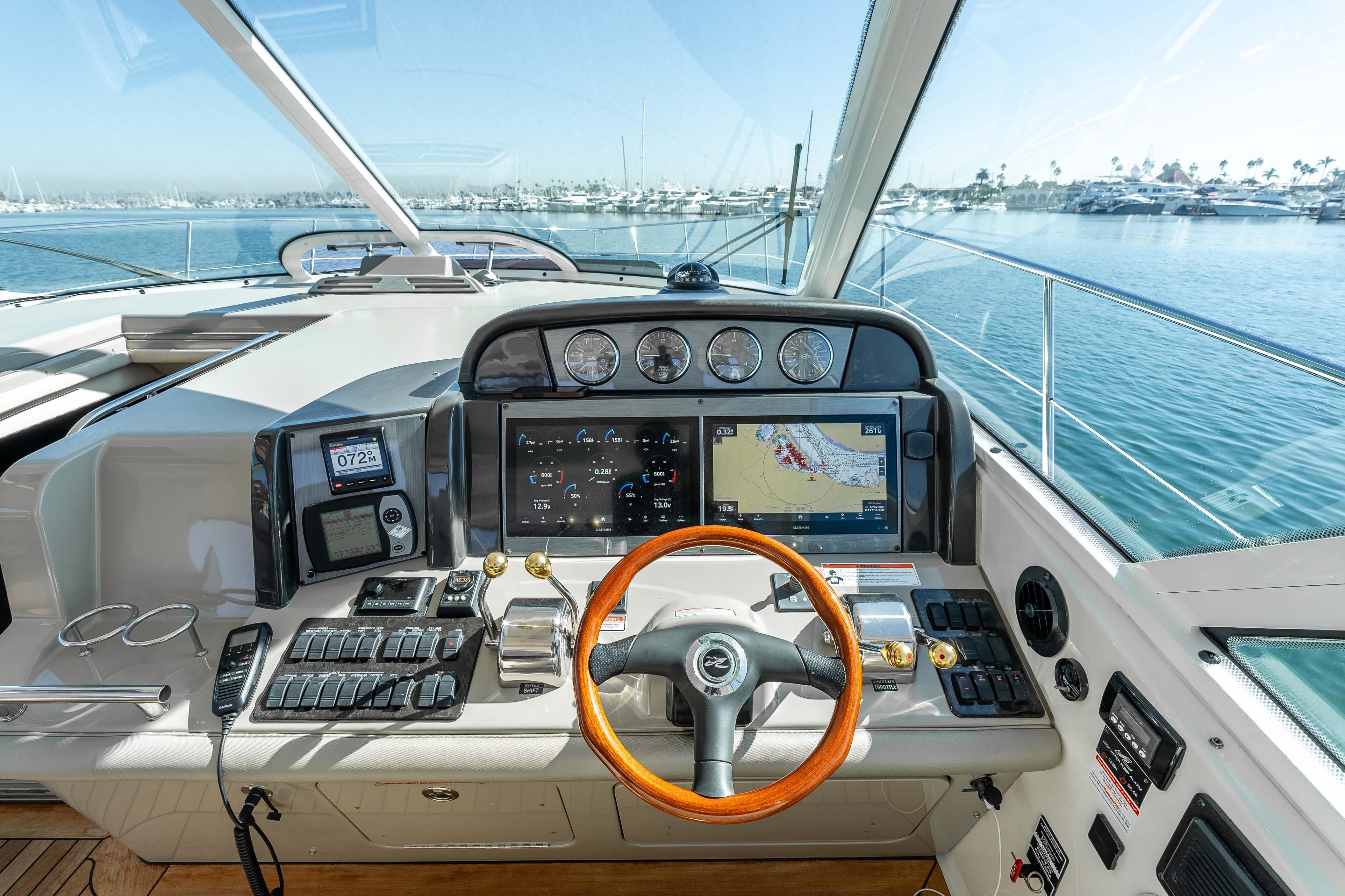Helm of 2007 Sea Ray 48 Sundancer yacht with navigation screens and controls.
