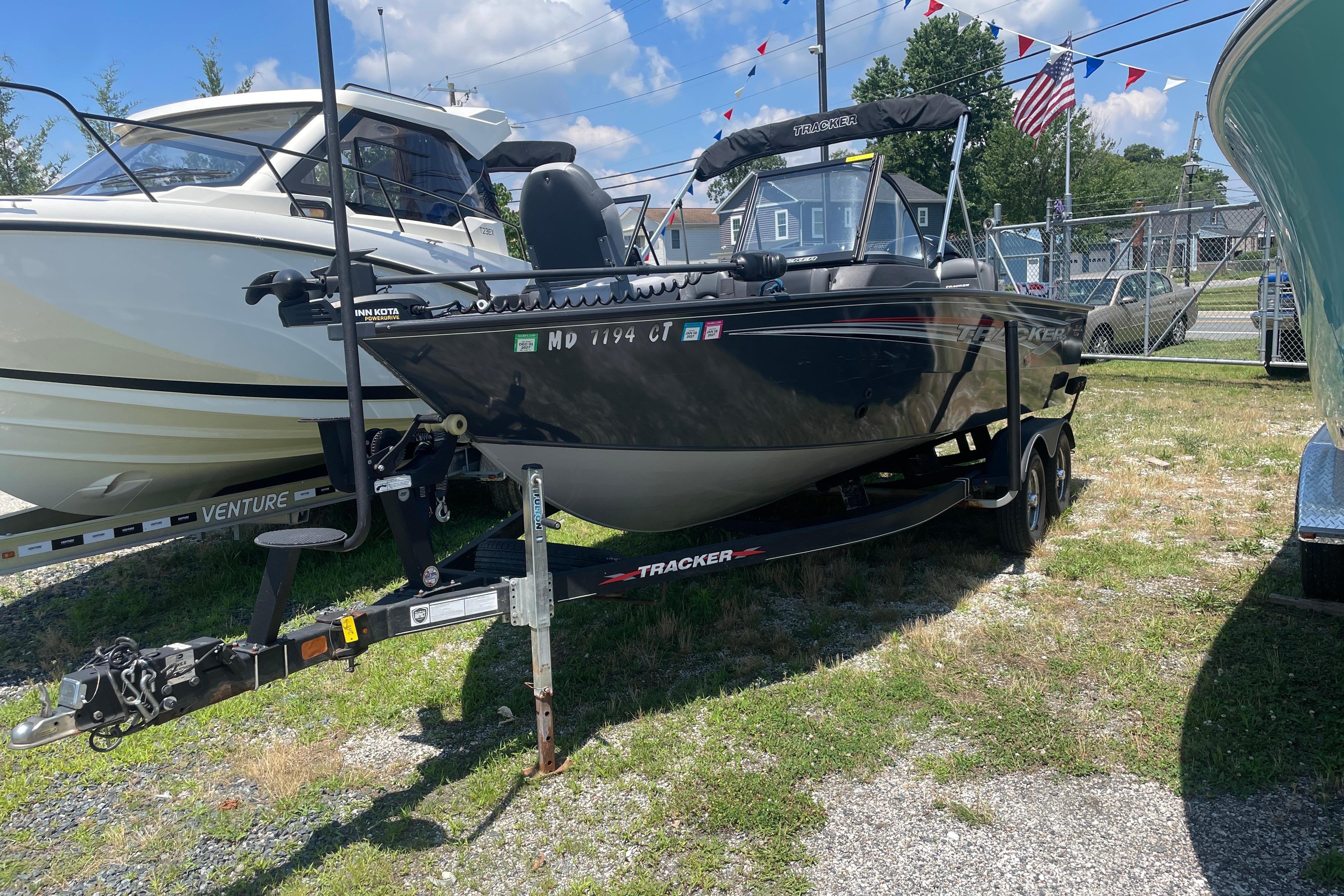 2022 Tracker Targa V-18 WT boat on trailer, parked outdoors under a sunny sky.
