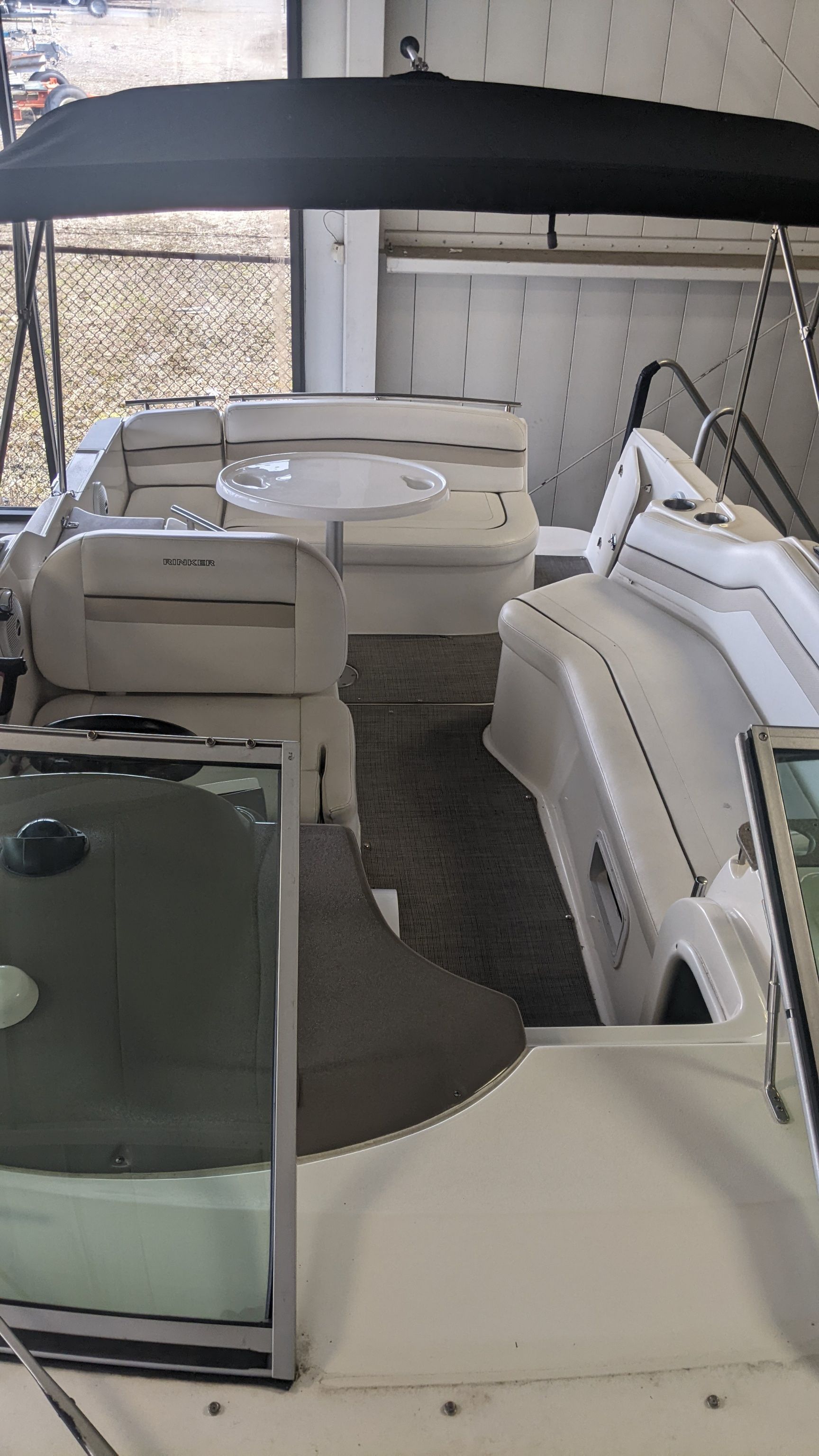 Interior of a 2006 Rinker 250 EC boat with seating area.