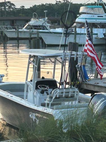2020 Sportsman Heritage 231 Center Console boat docked with American flag.