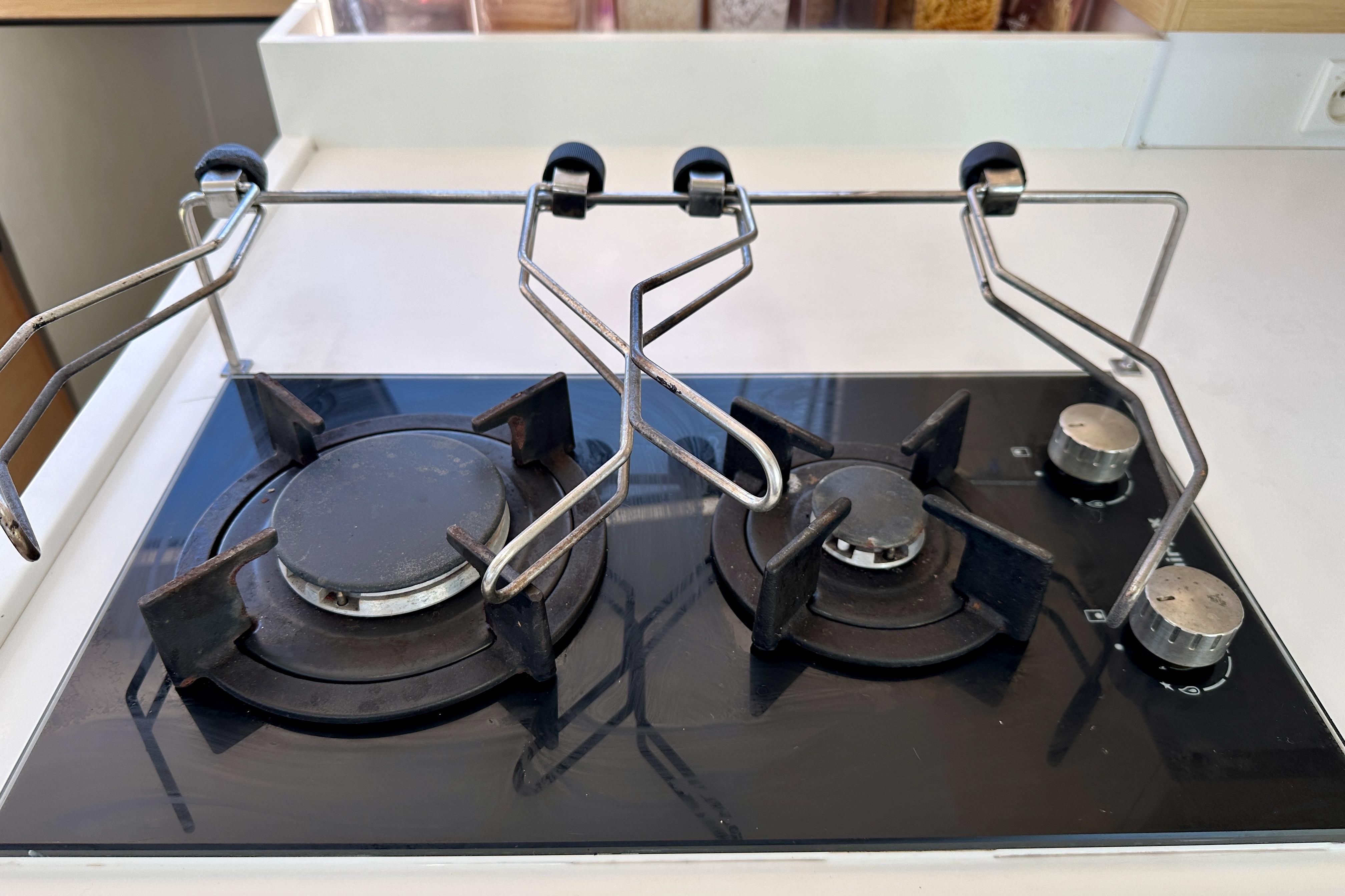 Modern gas stove on Outremer 45 yacht, 2019 model, with two burners and metal supports.