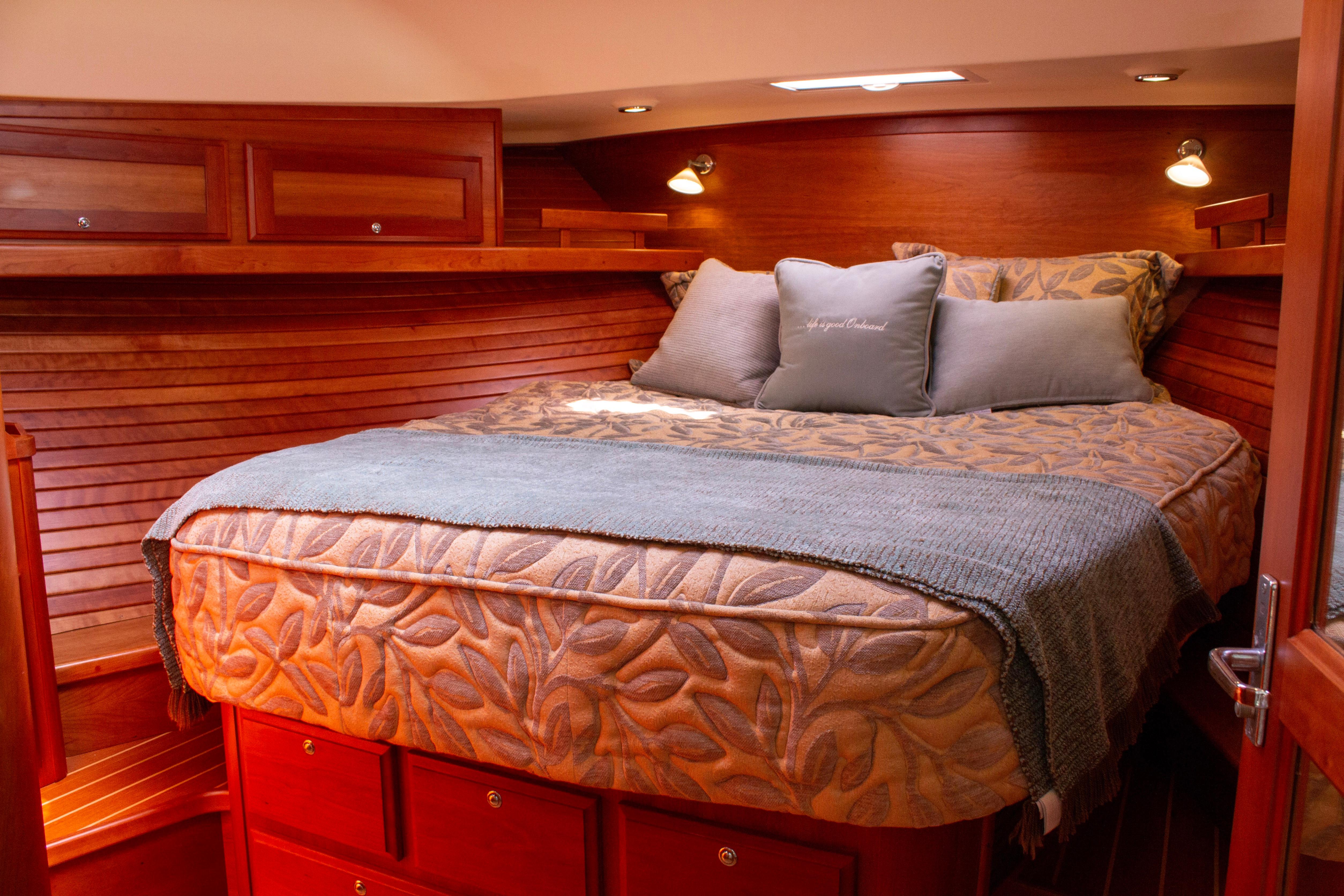 Luxurious cabin interior of 2013 Sabre 38 Salon Express yacht with cozy bedding.