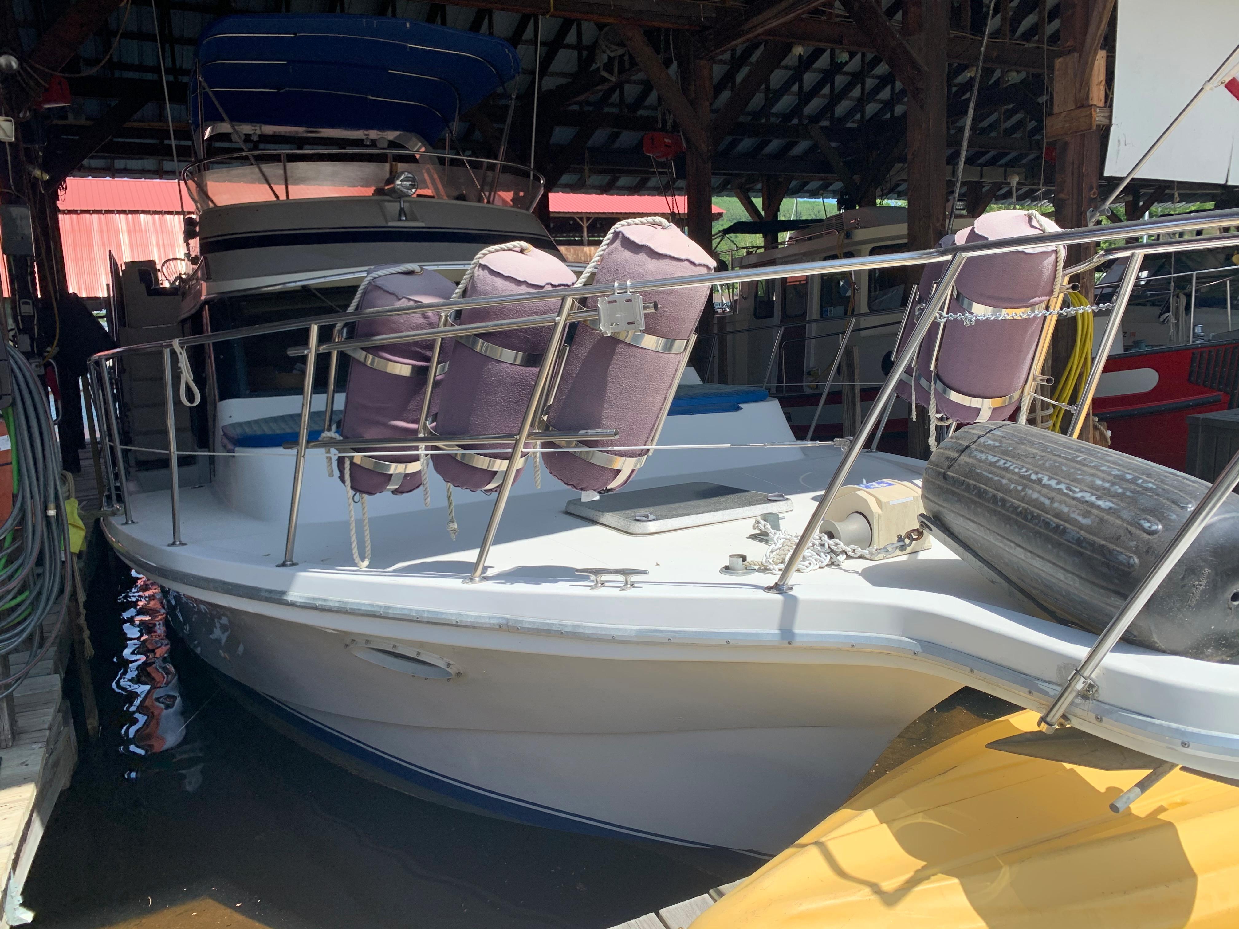 1988 Blue Water Coastal Cruiser docked in a covered marina.