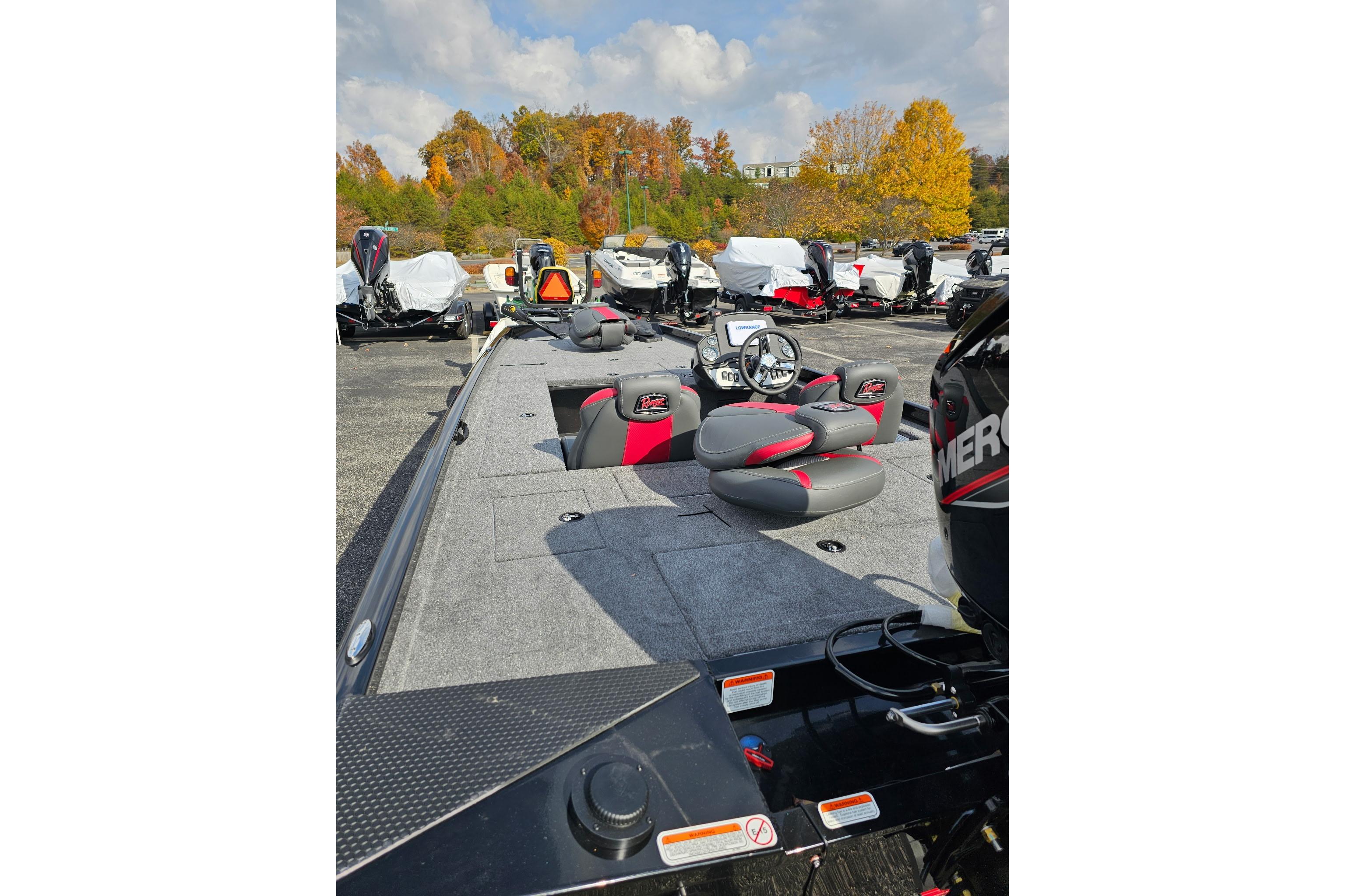 2026 Ranger RT188C fishing boat with gray and red seating, parked outdoors.