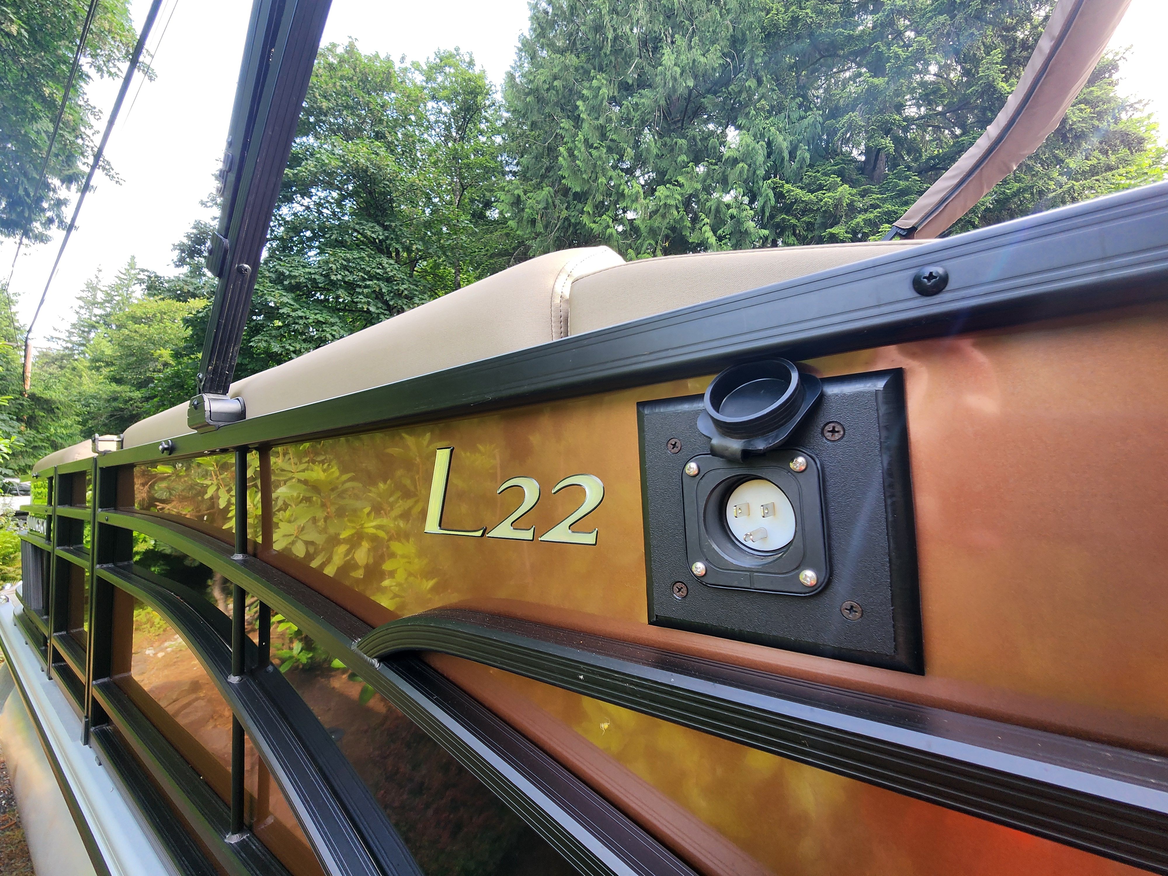 Close-up of a Bennington 22 LSB boat with L22 logo and power outlet.