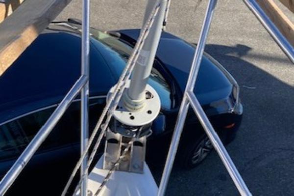 Sailboat mast of 1989 Catalina 30, parked car visible below.