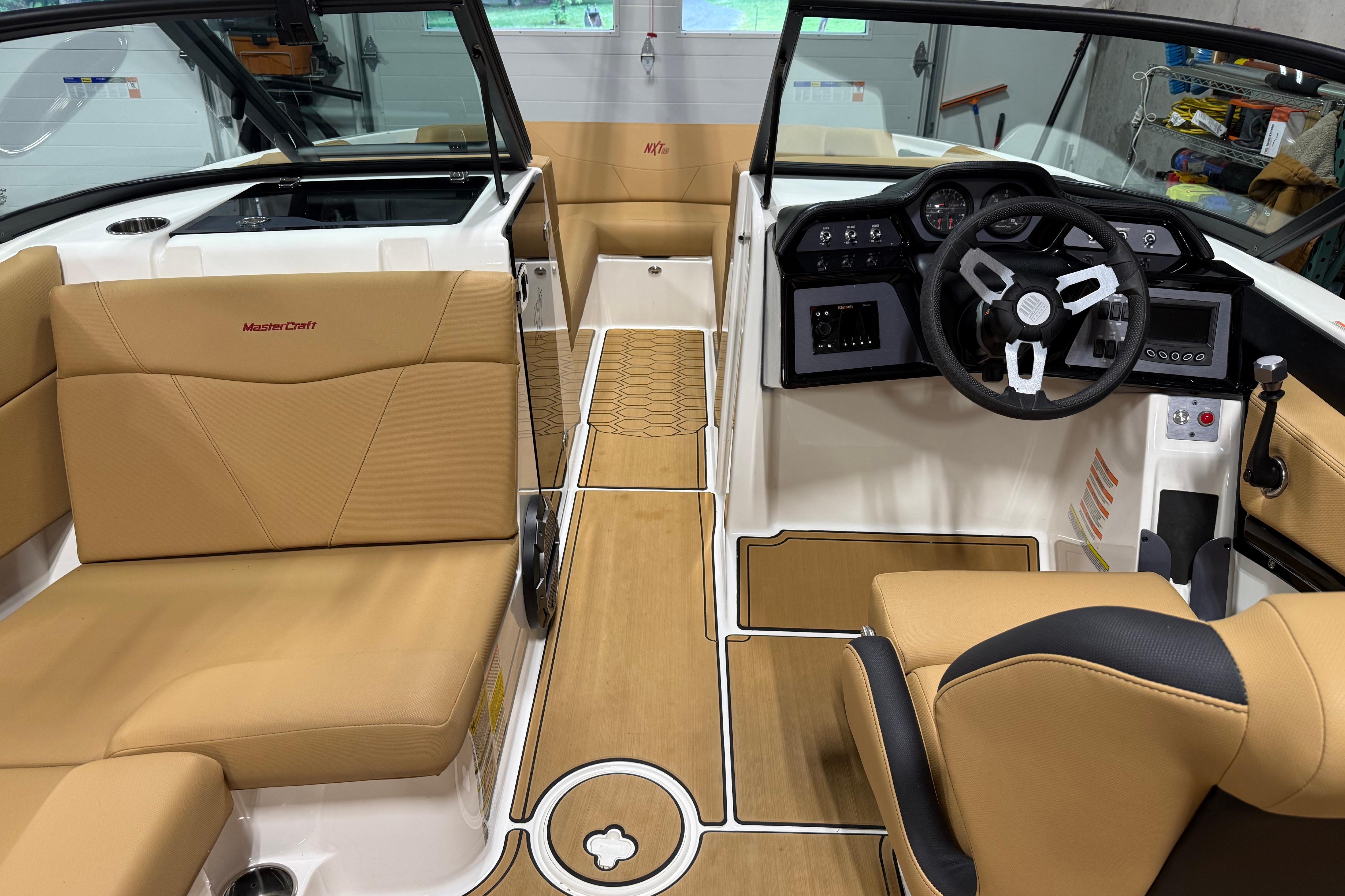 2022 MasterCraft NXT24 boat interior with tan seating and modern dashboard design.