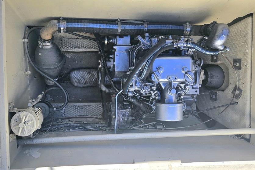 Engine compartment of a 1979 Catamaran Ocean Winds 33, showcasing mechanical components.