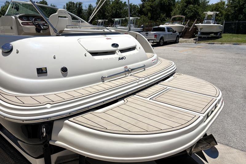 2007 Sea Ray 240 Sundeck boat with spacious swim platform in a marina setting.
