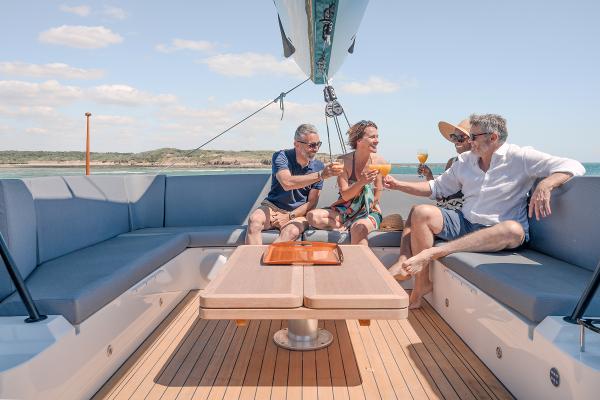 People enjoying drinks on a 2025 Privilege Signature 650 yacht deck.