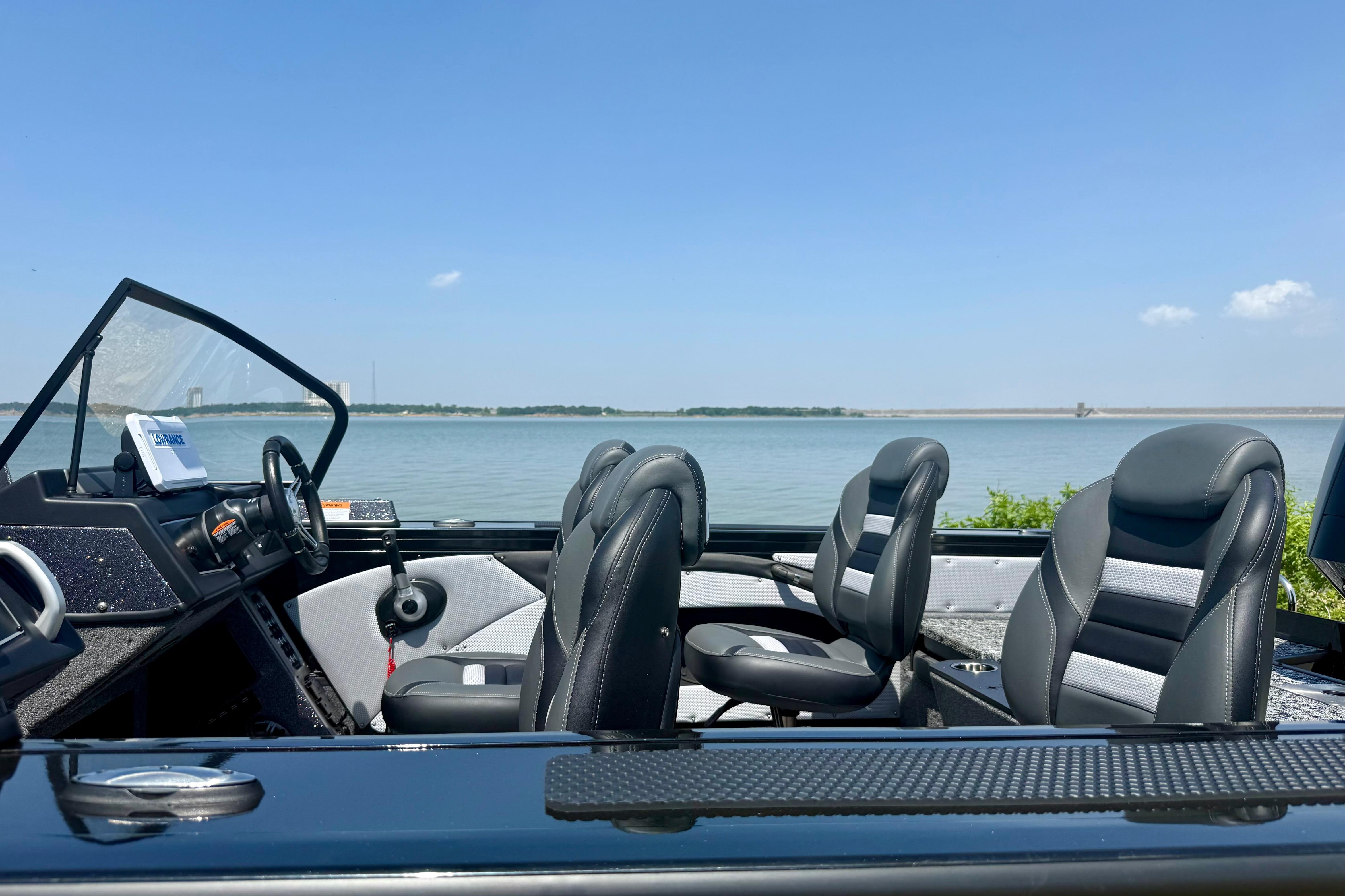 2026 Ranger VX1788 WT boat interior with lake view, featuring sleek black seating.