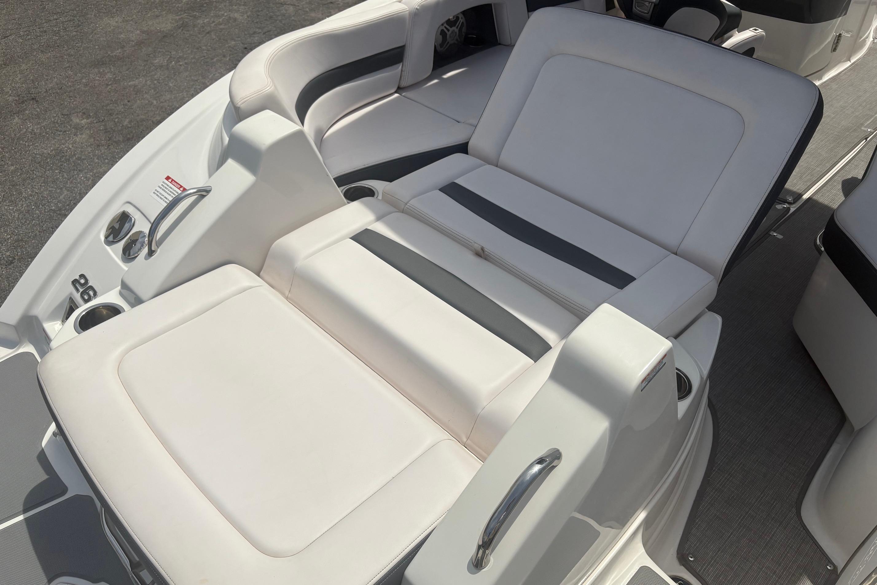 2019 Chaparral 264 Sunesta boat interior with white cushioned seating and sleek design.