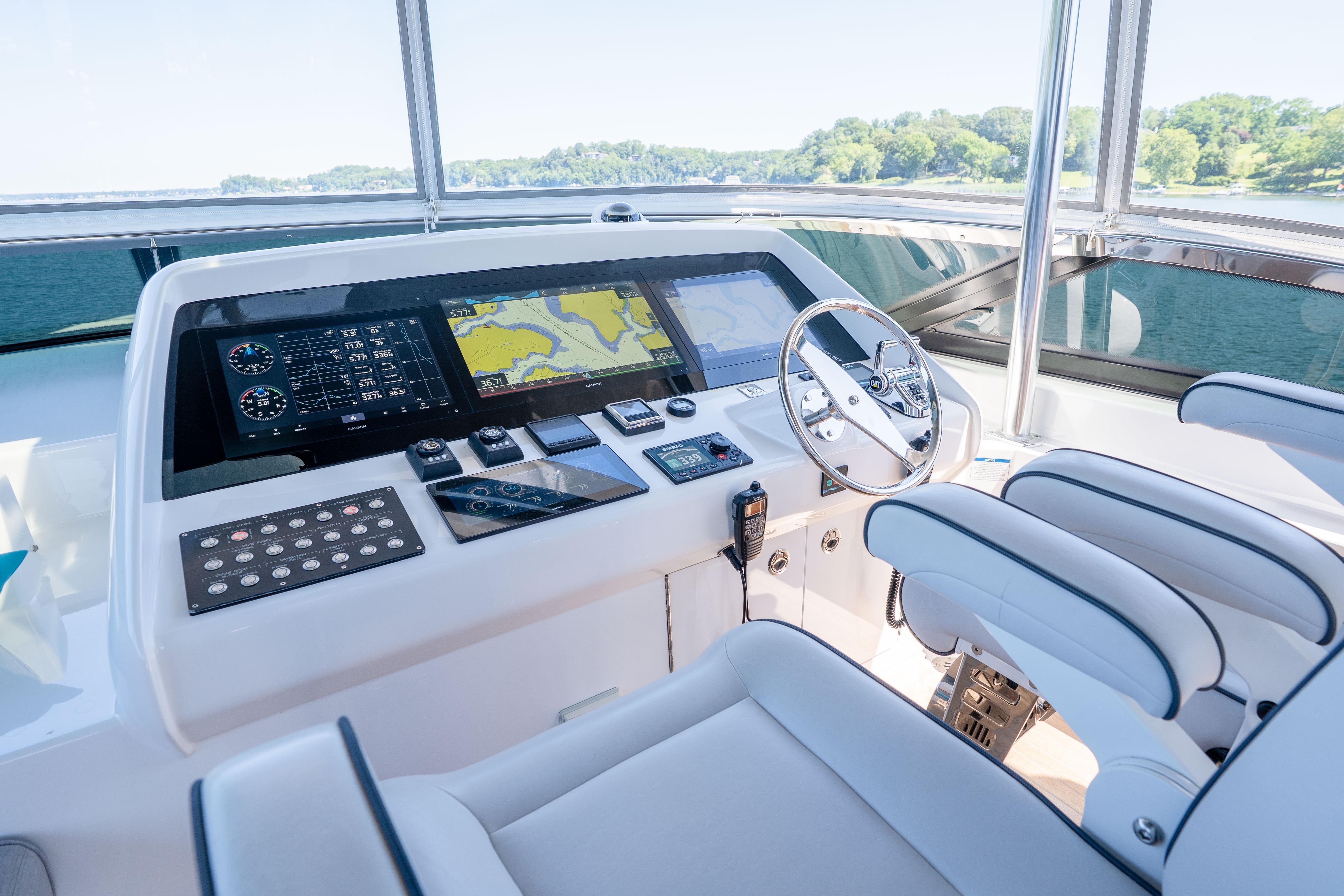 Helm of 2021 Hatteras M75 Panacera yacht with advanced navigation displays and controls.