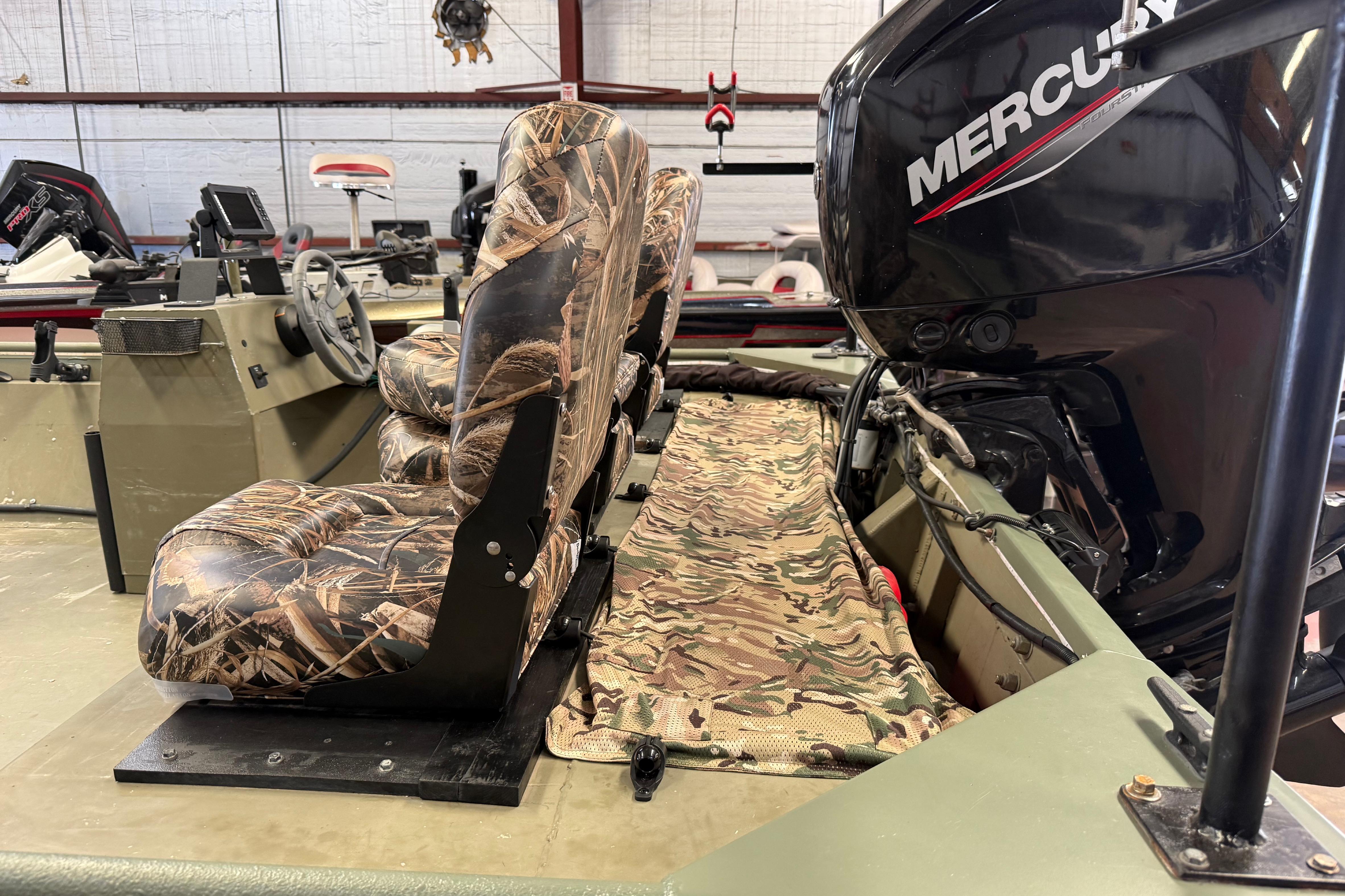 2020 Lowe Roughneck 2070 Big River boat with camo seats and Mercury outboard motor.