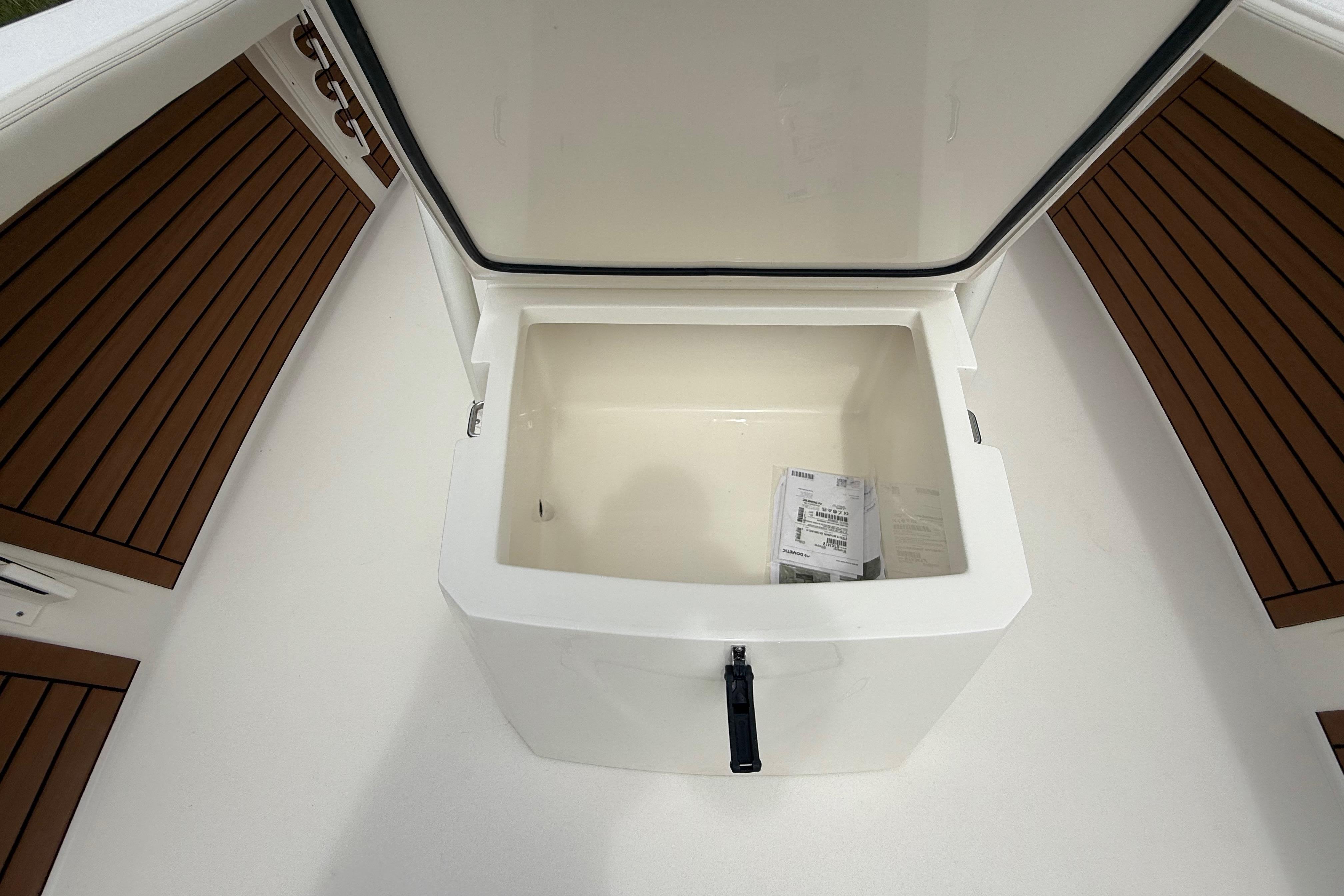 Open storage compartment on 2026 Pathfinder 2700 Open boat, featuring teak-style flooring.
