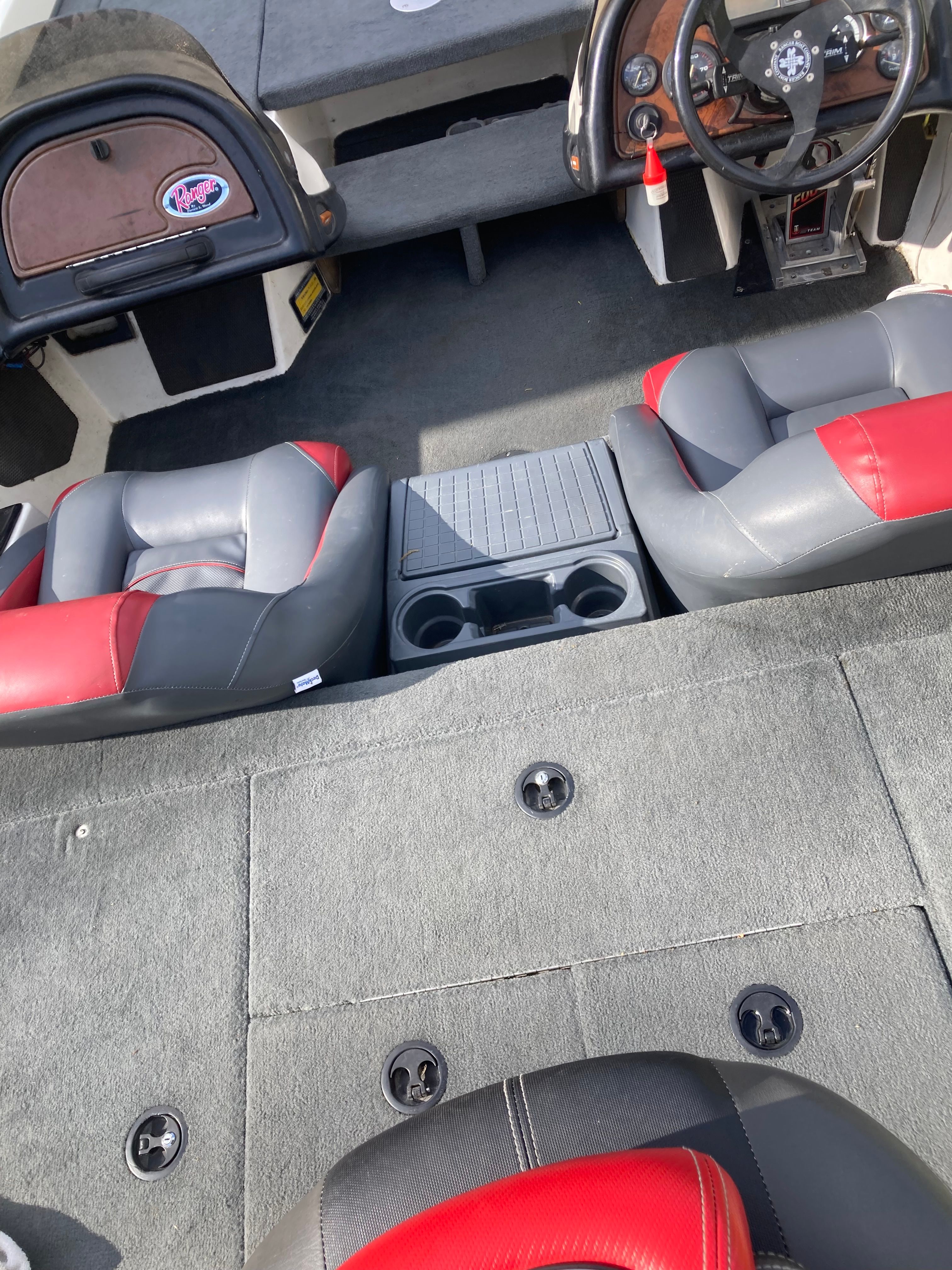 Interior view of a 2002 Ranger 522DVX Comanche with red and gray seats.