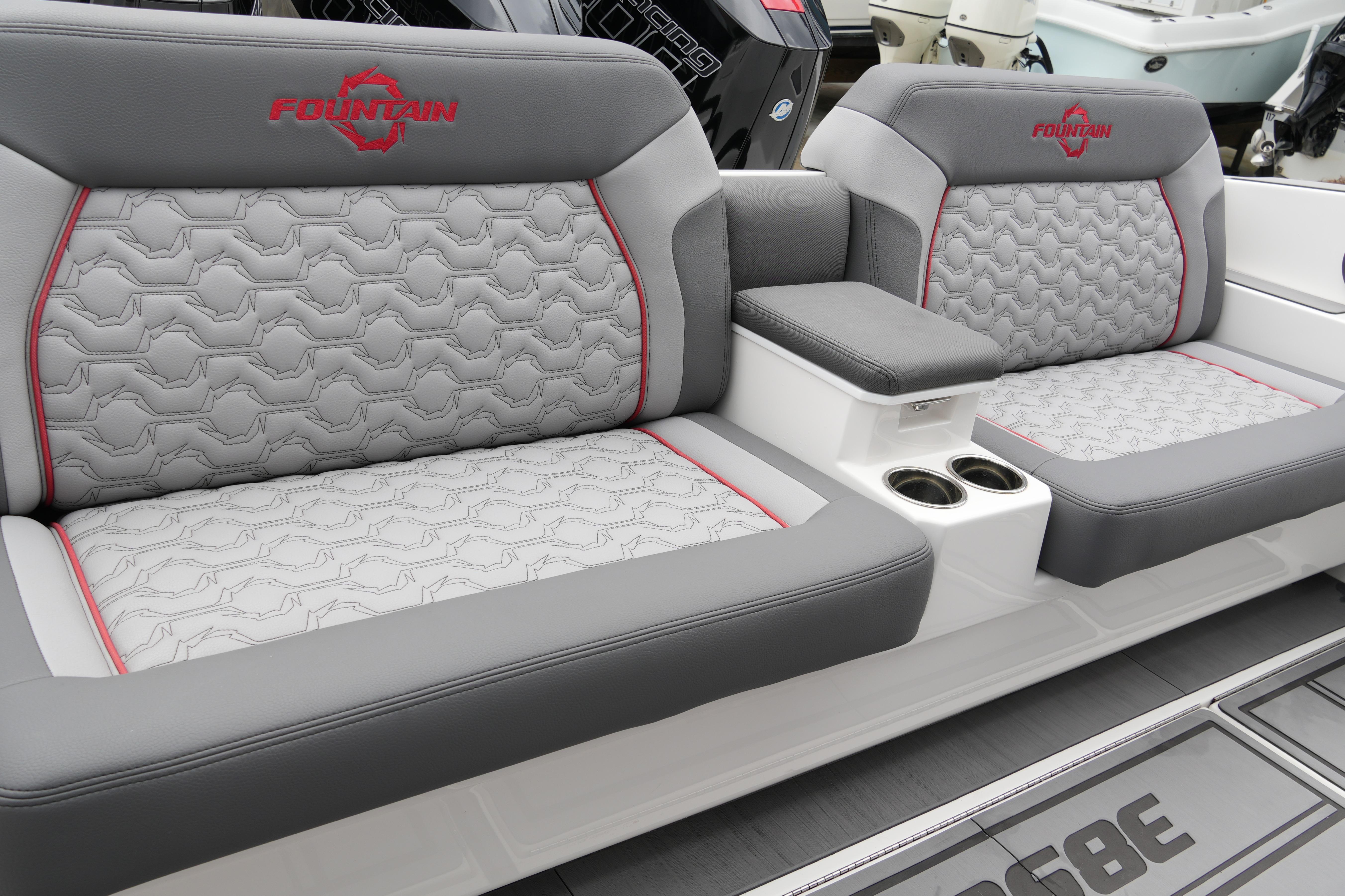 2025 Fountain 38 SCX boat seats with gray upholstery and red accents.