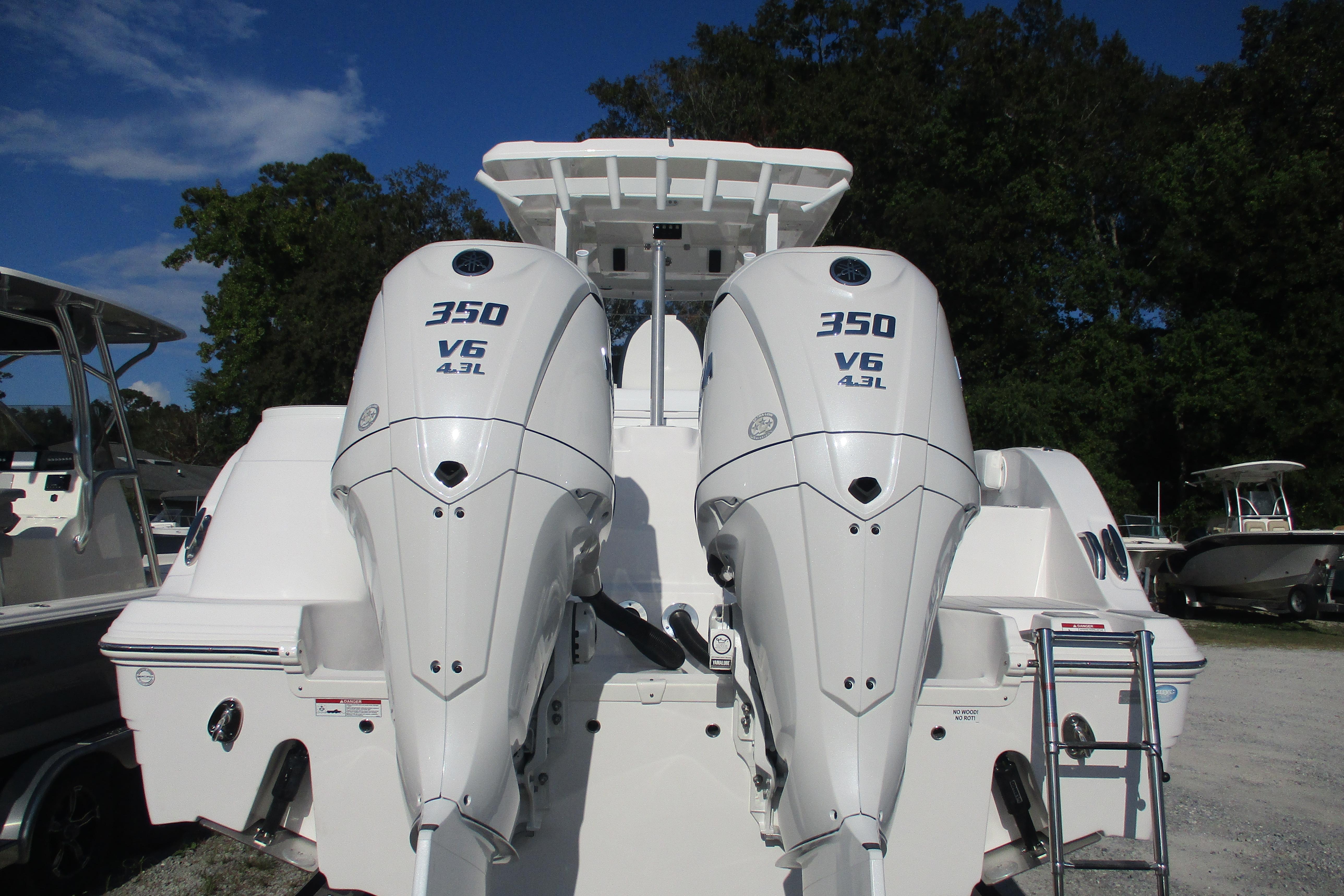 2026 Sea Fox 328 Commander with twin 350 V6 outboard engines, docked outdoors.
