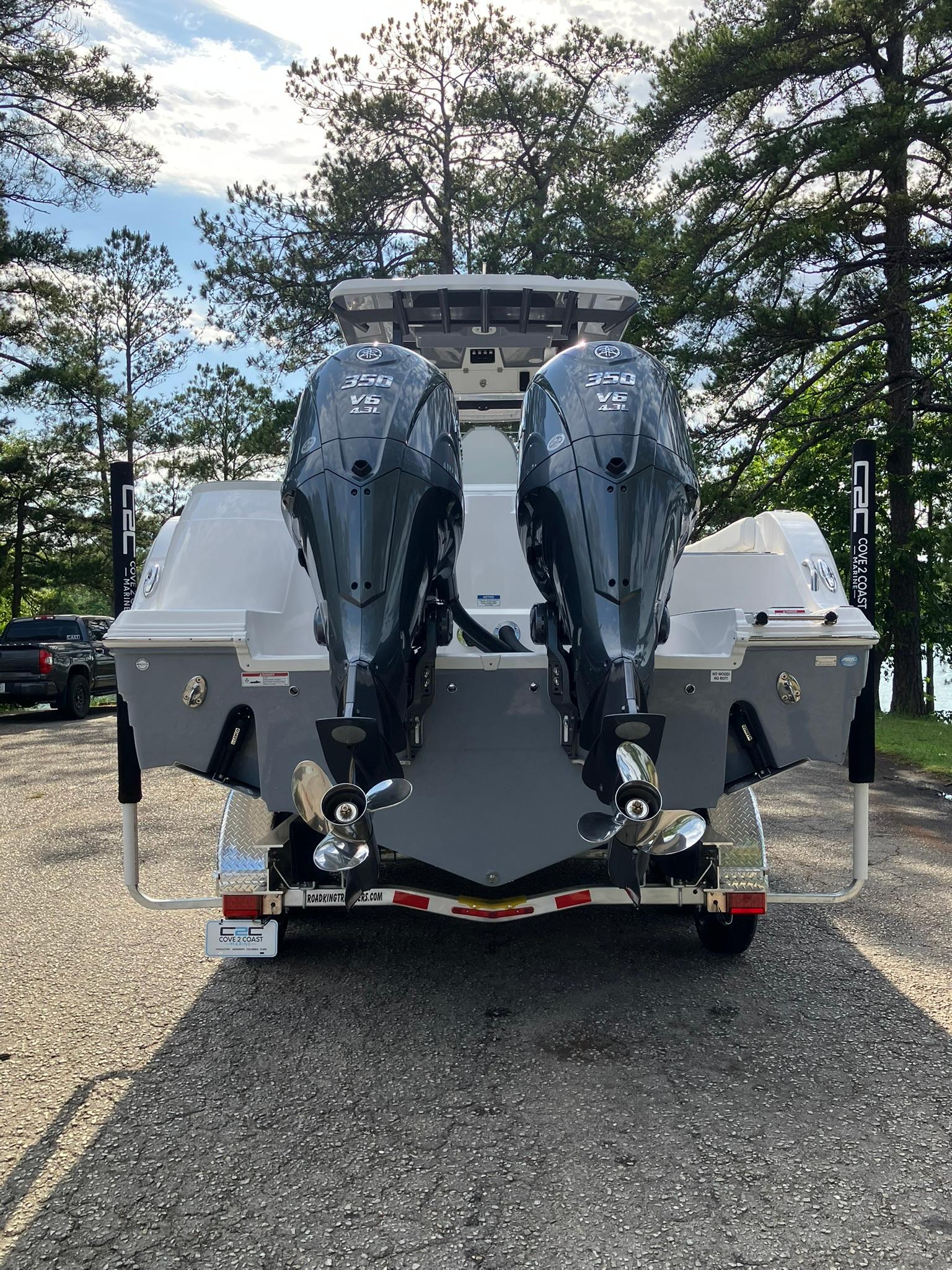 2025 Sea Fox 328 Commander boat with dual outboard engines on a trailer.