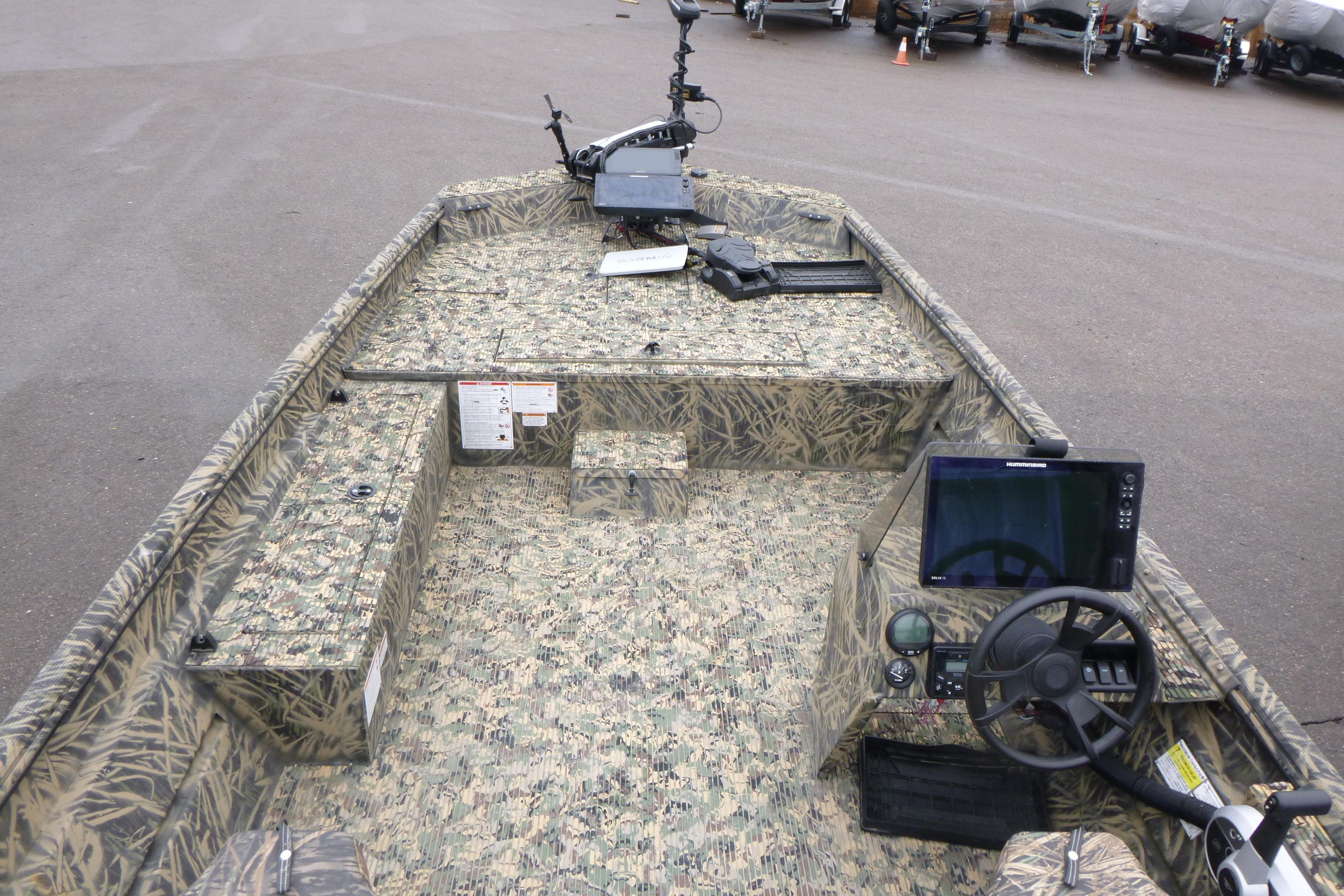 2024 Lowe Roughneck 2070 boat interior with camouflage design and modern controls.