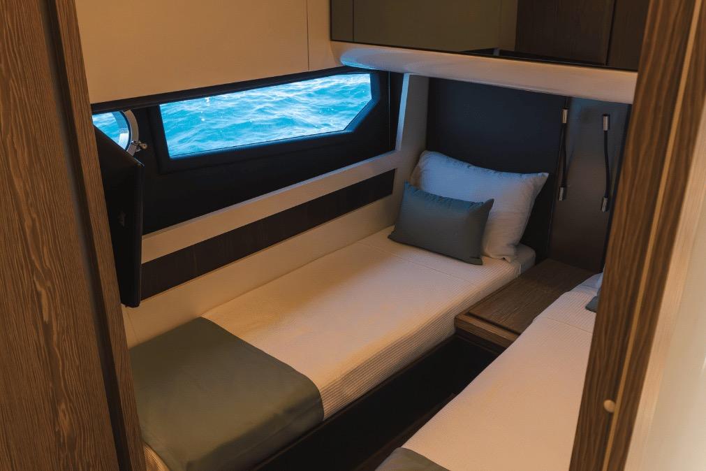Luxurious cabin interior of 2020 Azimut 60 yacht with twin beds and ocean view.