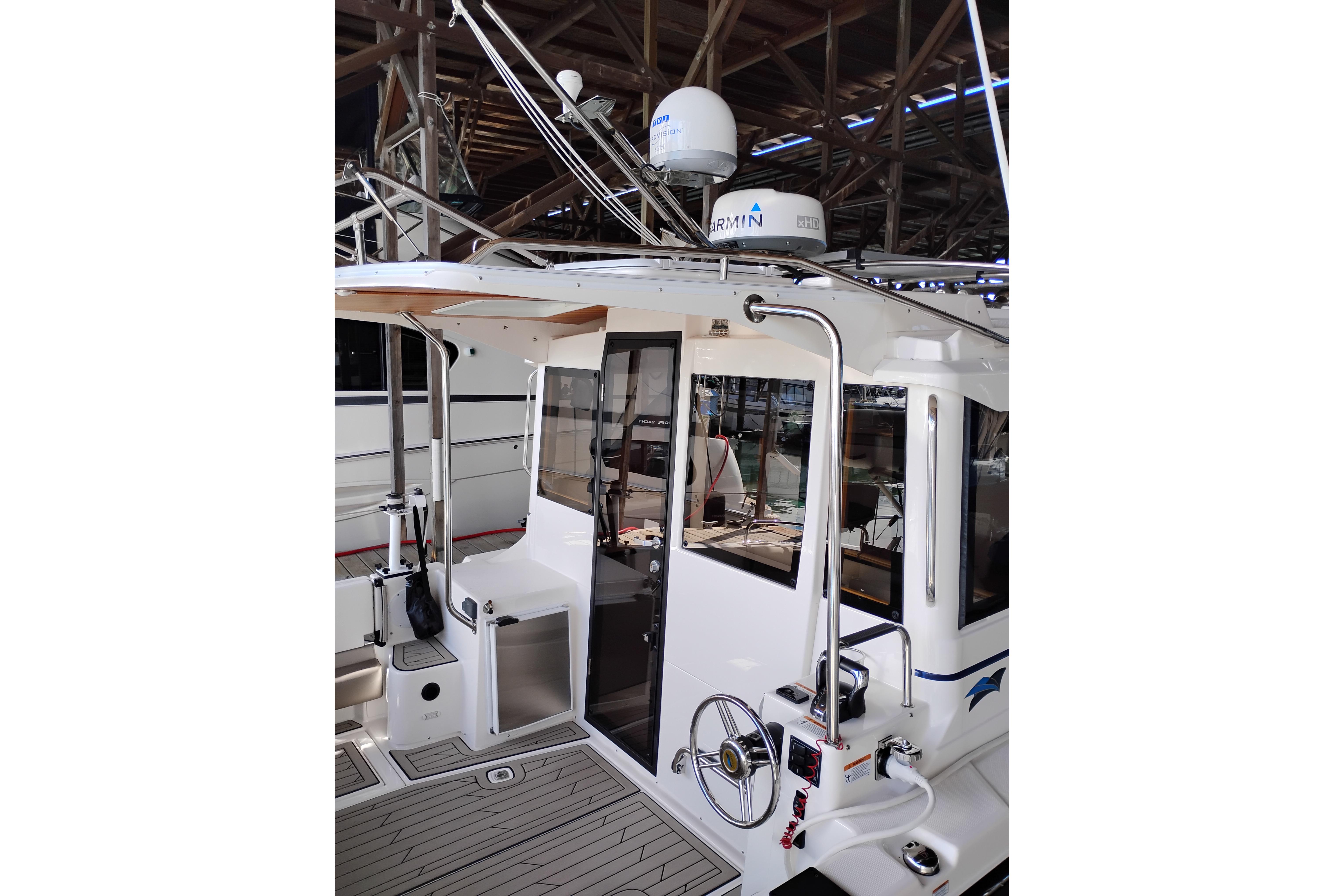 2022 Cutwater C-32 Coupe boat interior with Garmin equipment, docked in a marina.