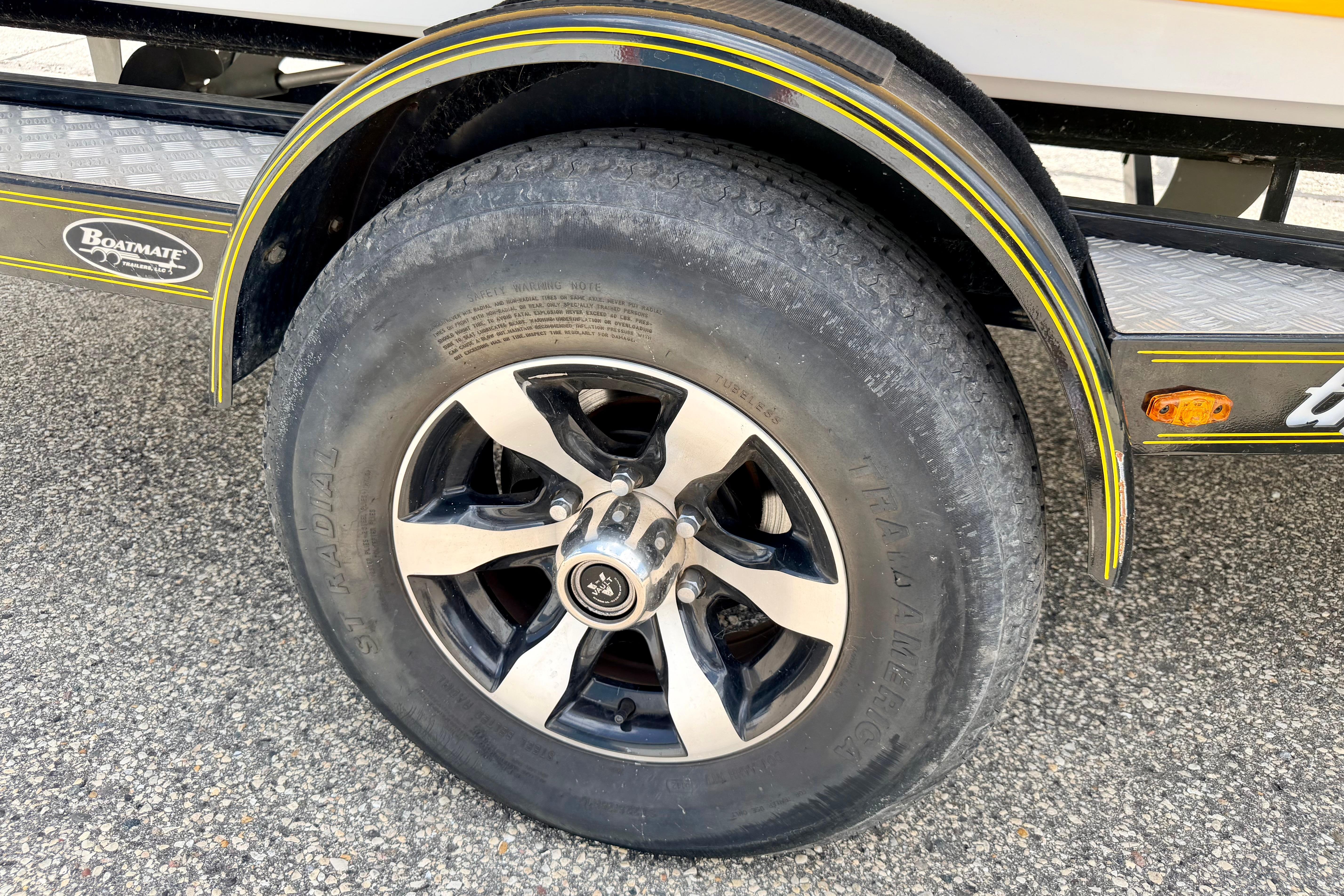 Trailer wheel of a 2014 Tigé R20 boat, featuring Boatmate trailer branding.