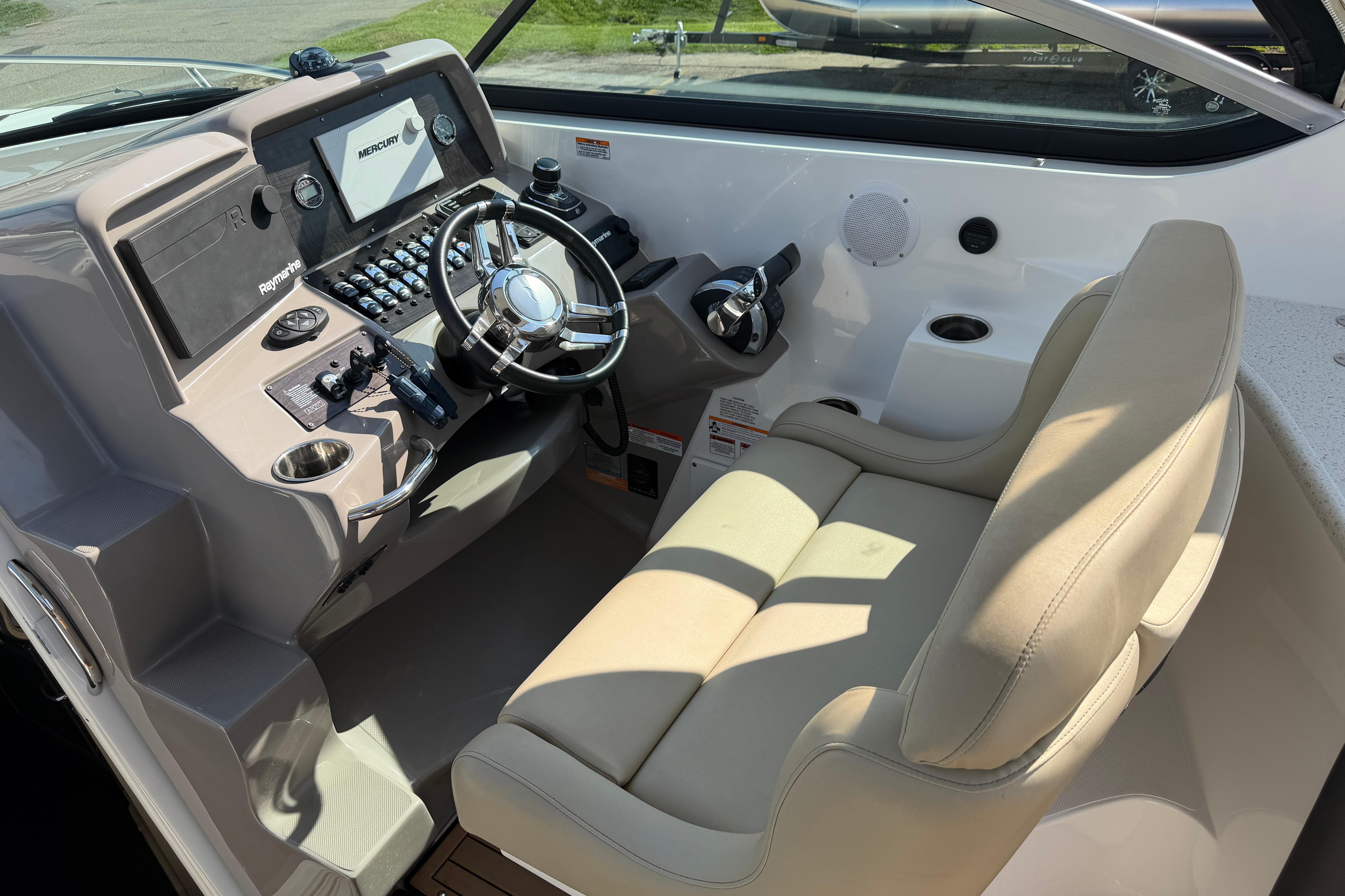 2019 Rinker EX 320 boat cockpit with steering wheel and control panel.