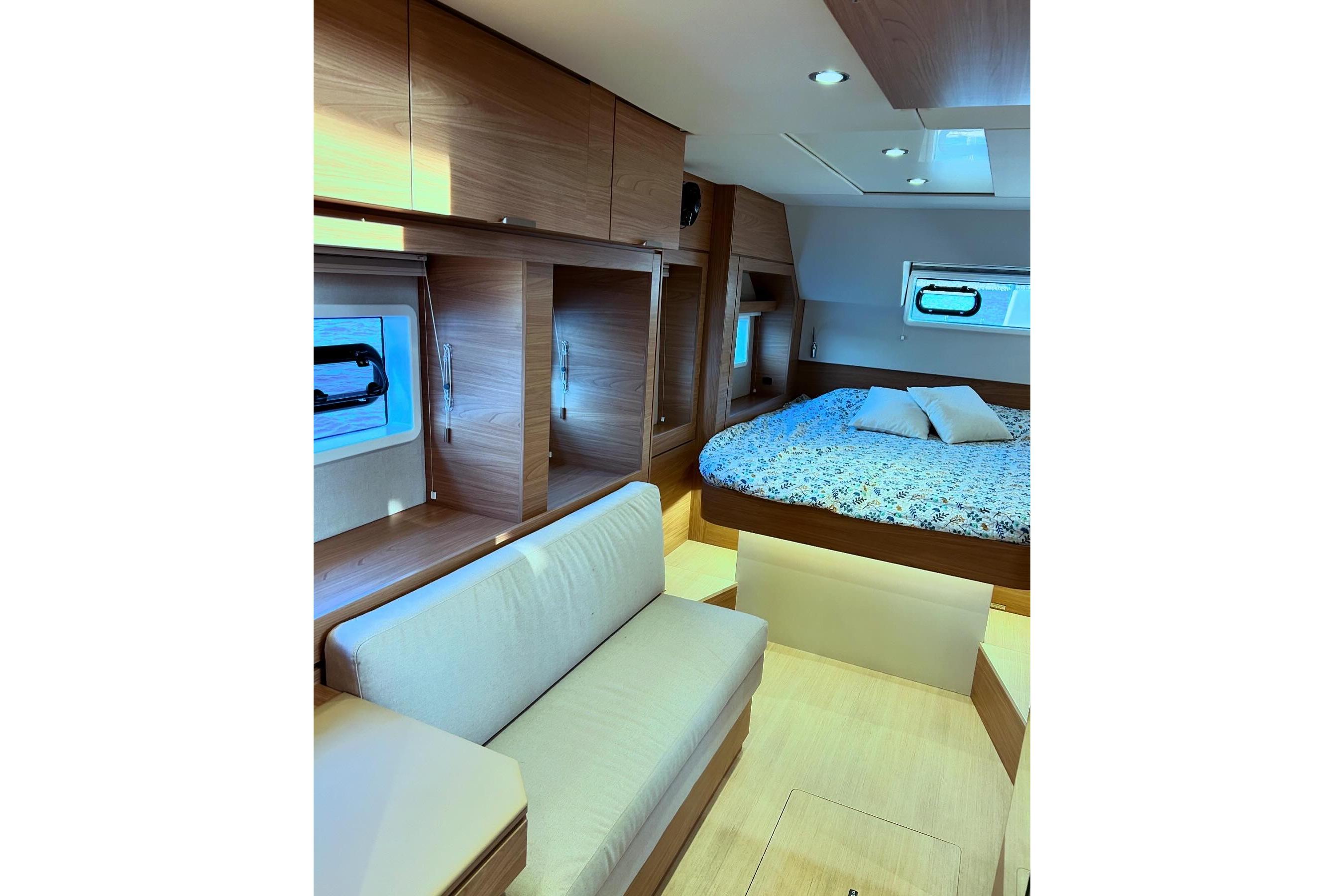 Luxurious interior of 2024 Bali 4.6 yacht with cozy bed and seating area.