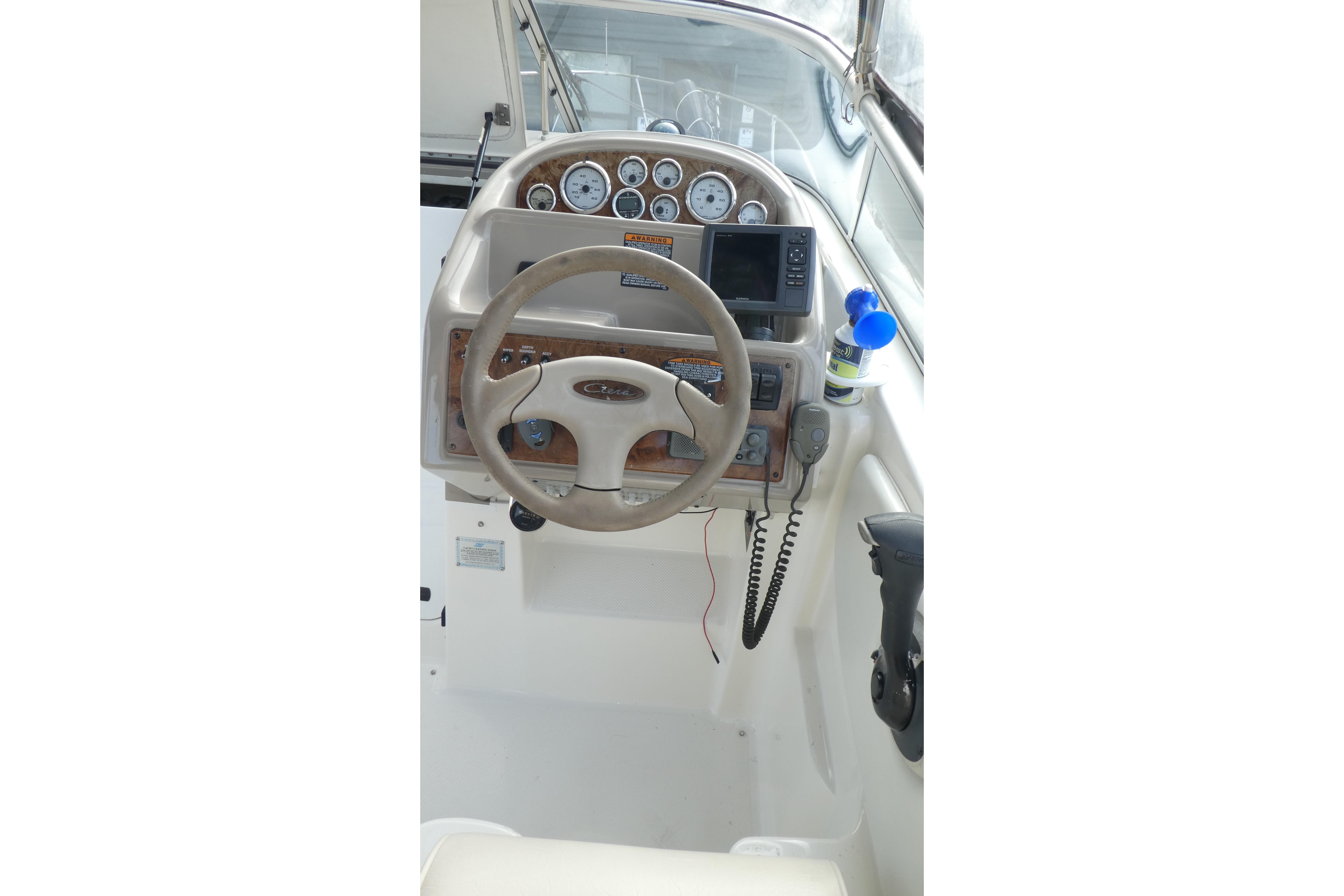 2002 Bayliner 2855 Ciera helm with steering wheel, gauges, and navigation equipment.