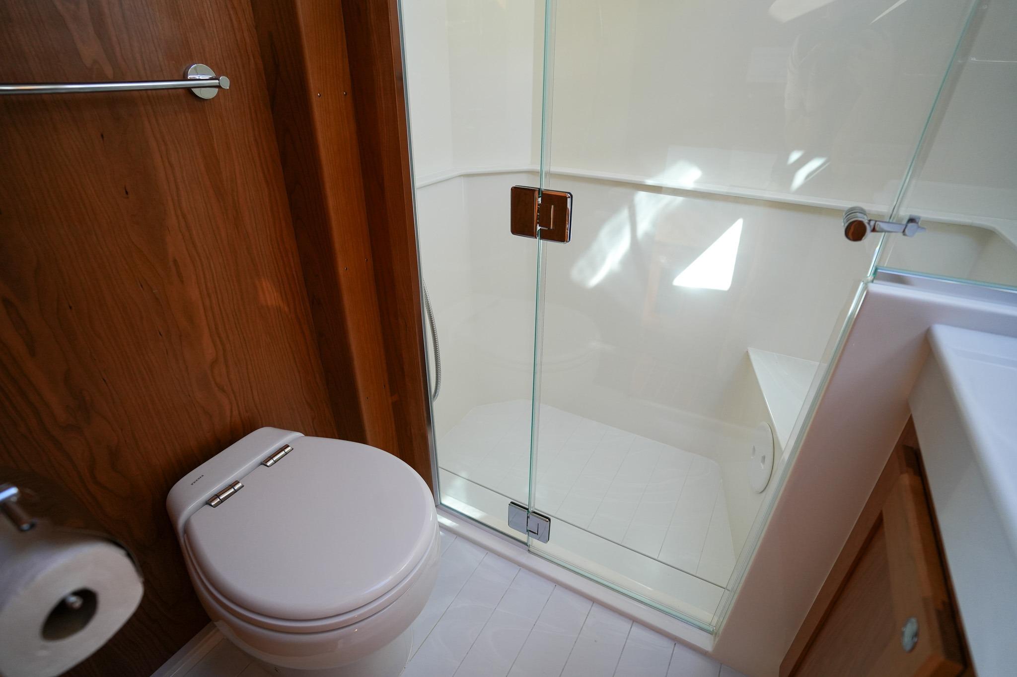 Bathroom interior of 2026 Sabre 51 Salon Express yacht with glass shower door.