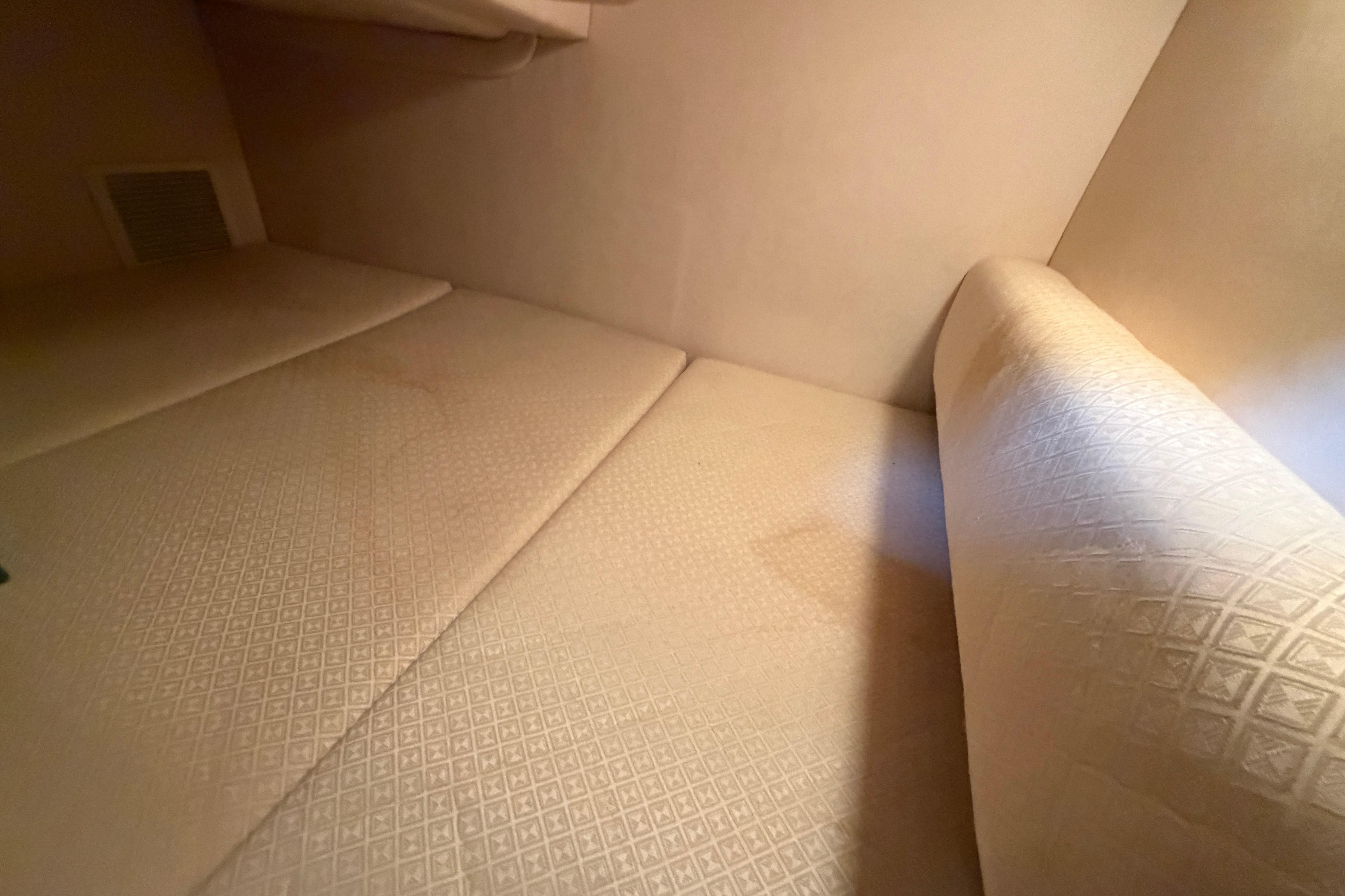 Interior cabin of 2004 Sea Ray Sundancer 260 with beige upholstery.