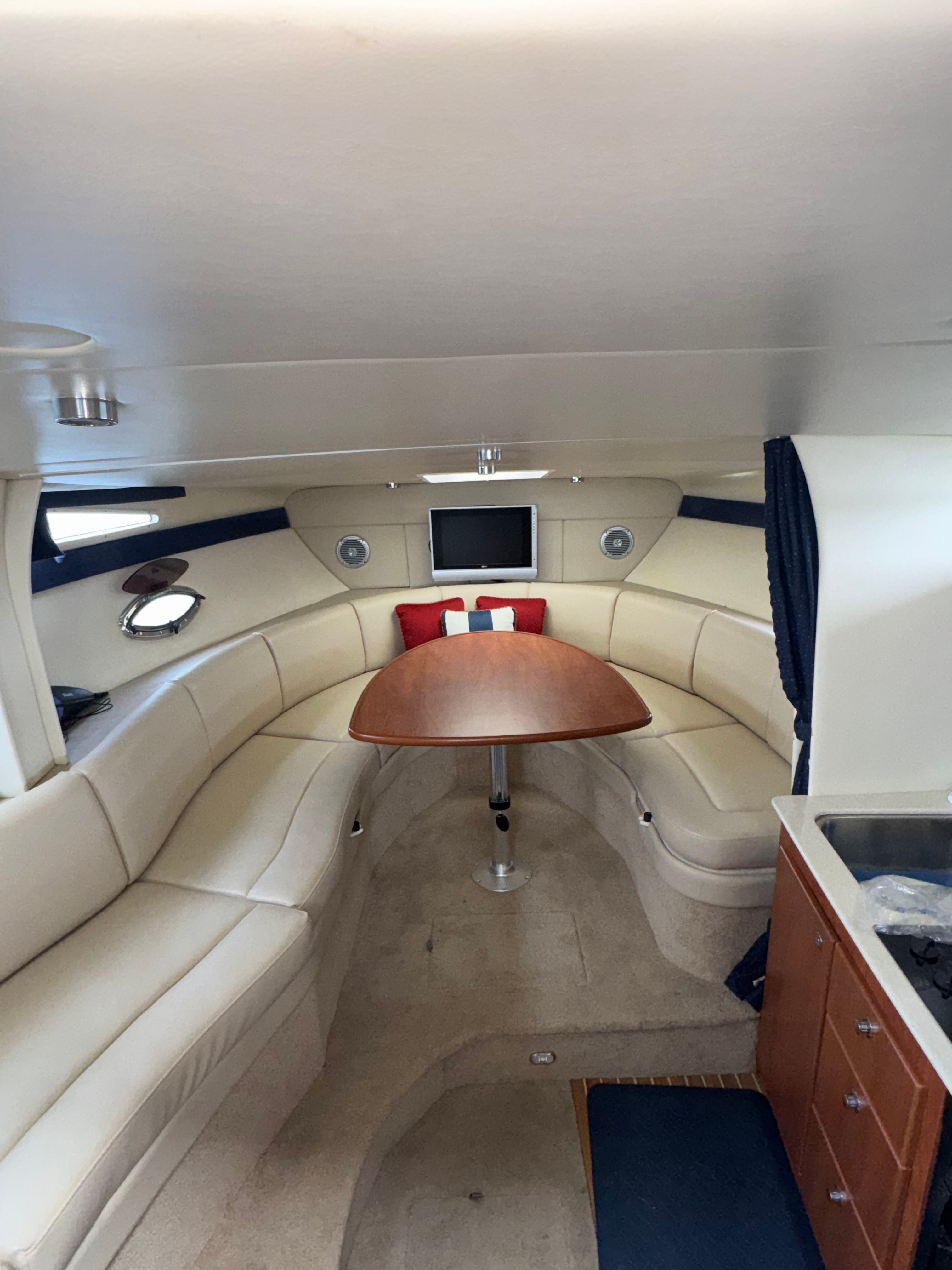 Interior of a 2008 Bayliner 340 yacht with seating area and table.