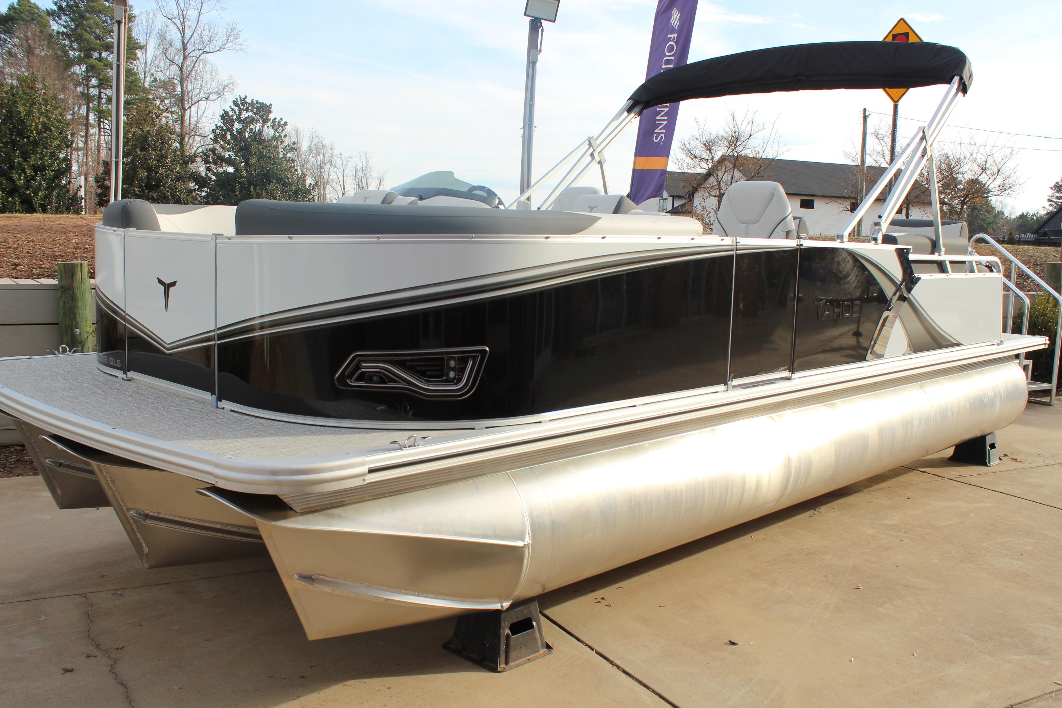 2026 Tahoe Pontoon LTZ boat with sleek design and modern features, docked outdoors.