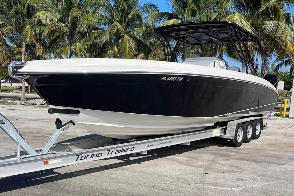 2009 Midnight Express 34 Open boat on trailer, surrounded by palm trees.