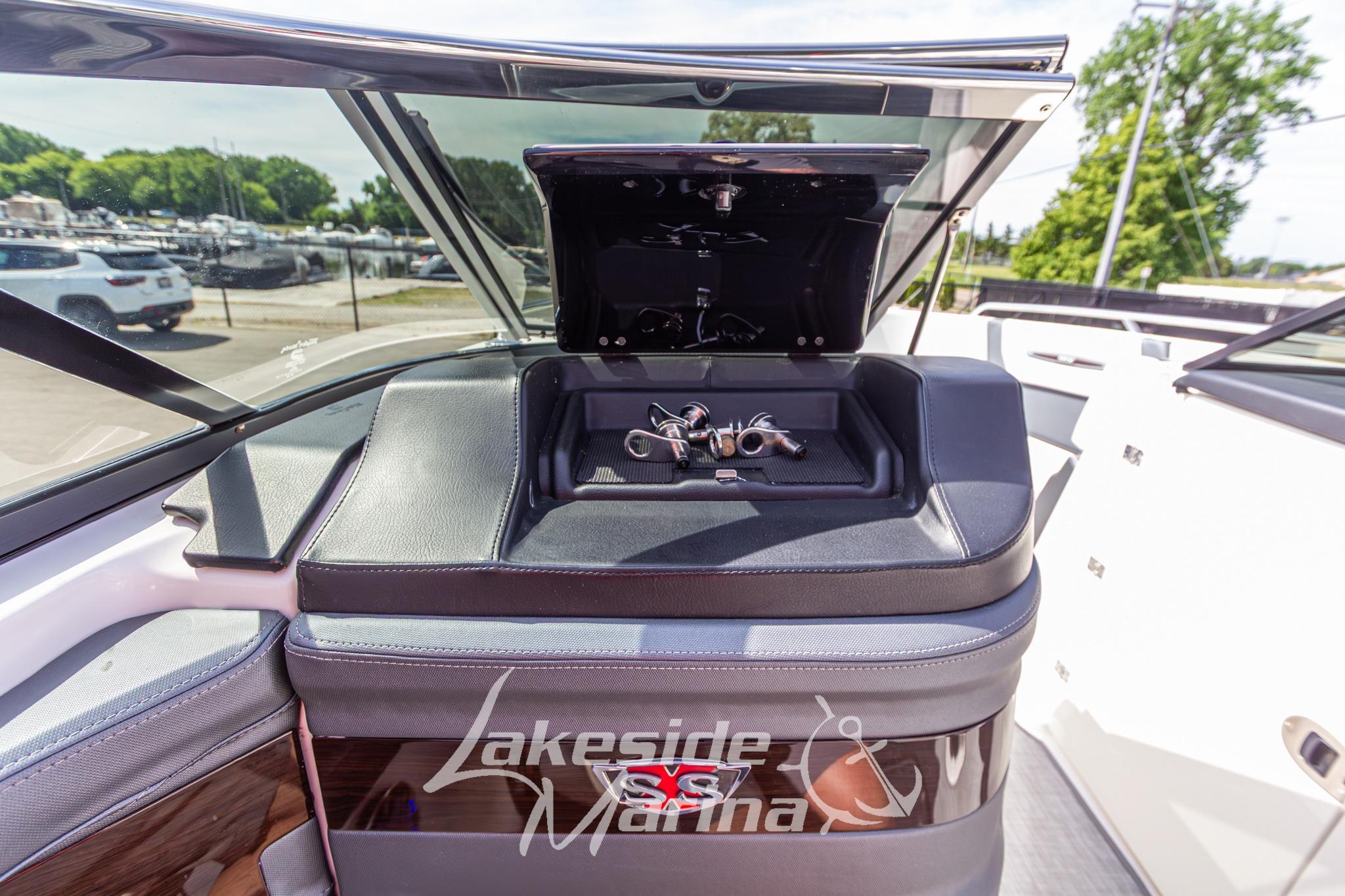 2021 Chaparral 287 SSX boat dashboard with open storage compartment at Lakeside Marina.
