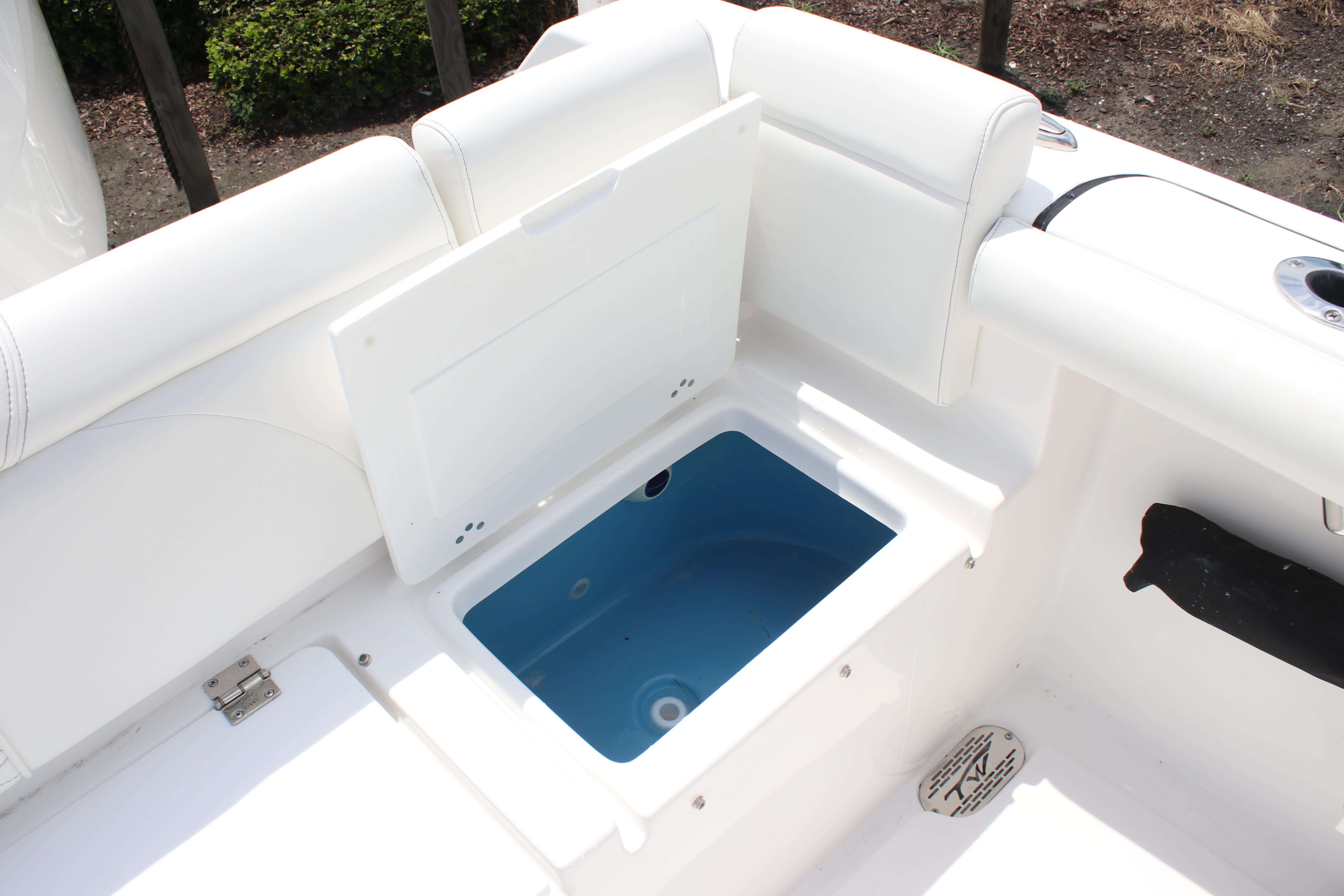 2026 Tidewater 272 LXF boat interior with open storage compartment.