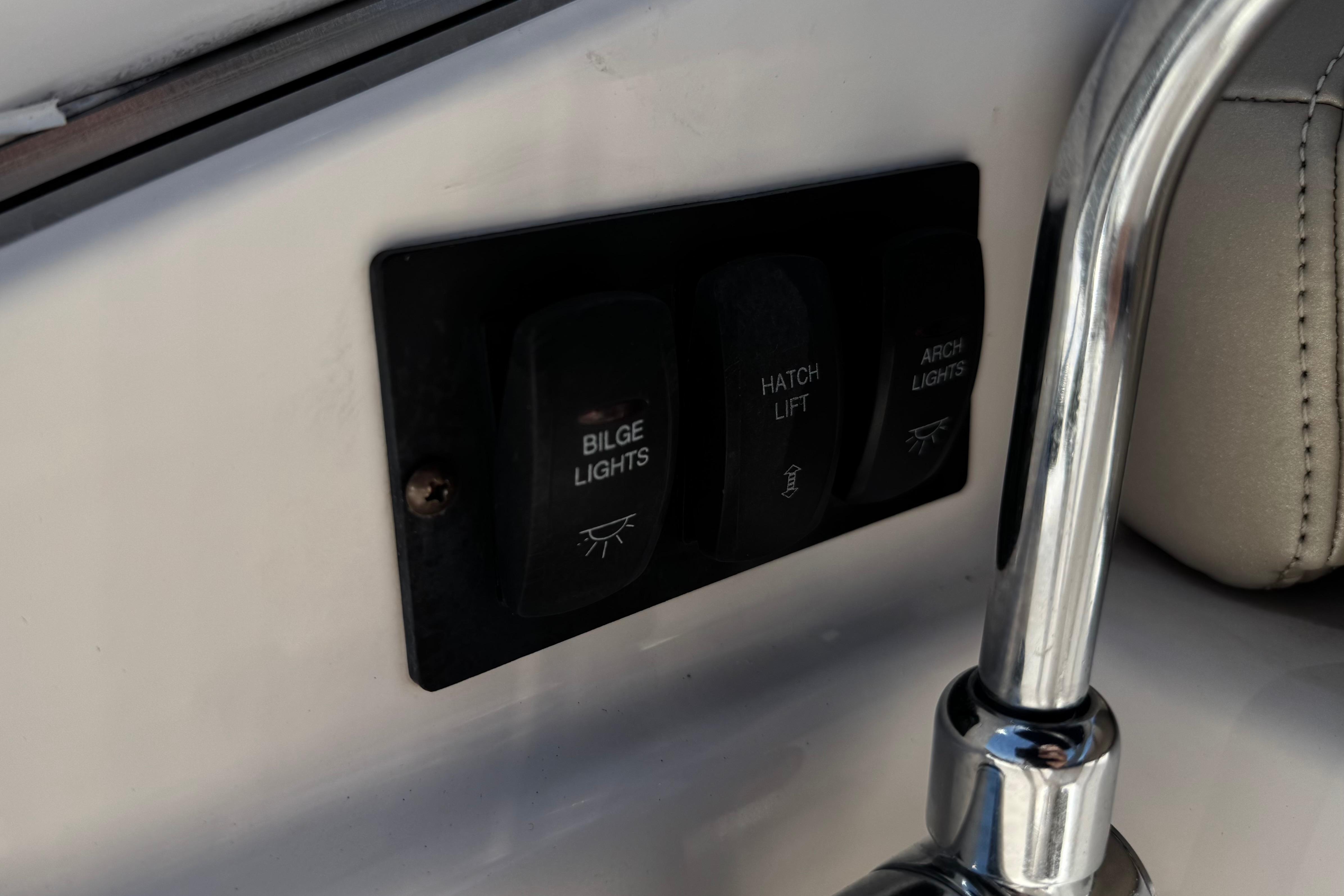 Control panel on a 2013 Regal 28 Express boat with switches for bilge lights.