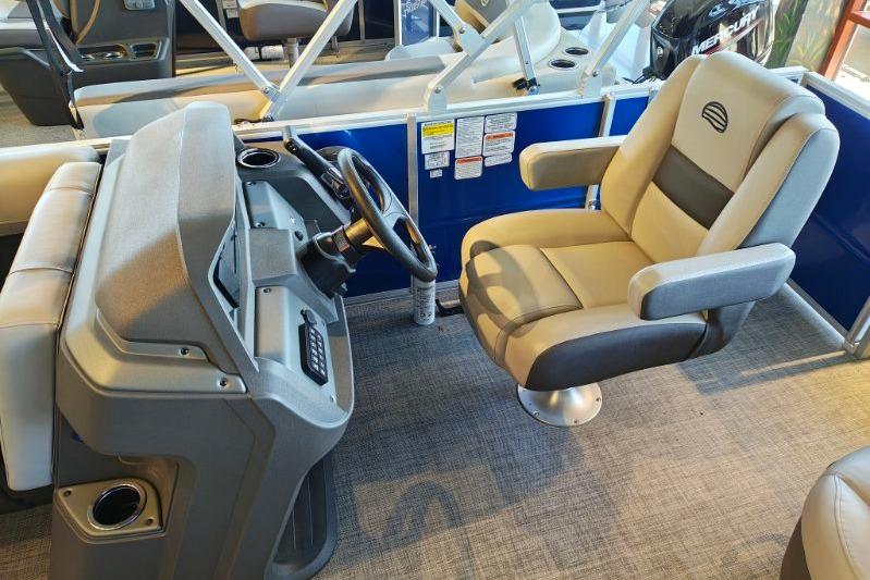2026 Sun Tracker Party Barge 18 DLX interior with steering console and captain's chair.