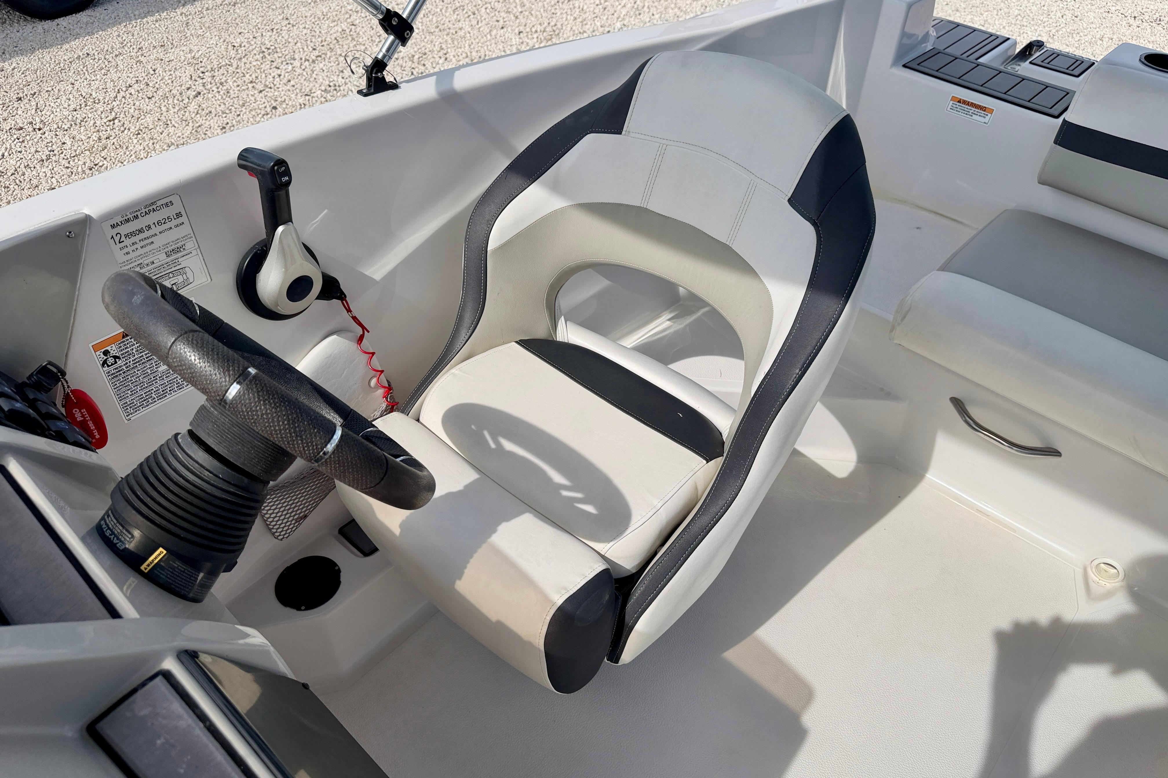 2021 Starcraft SVX 191 OB boat interior with steering wheel and captain's chair.