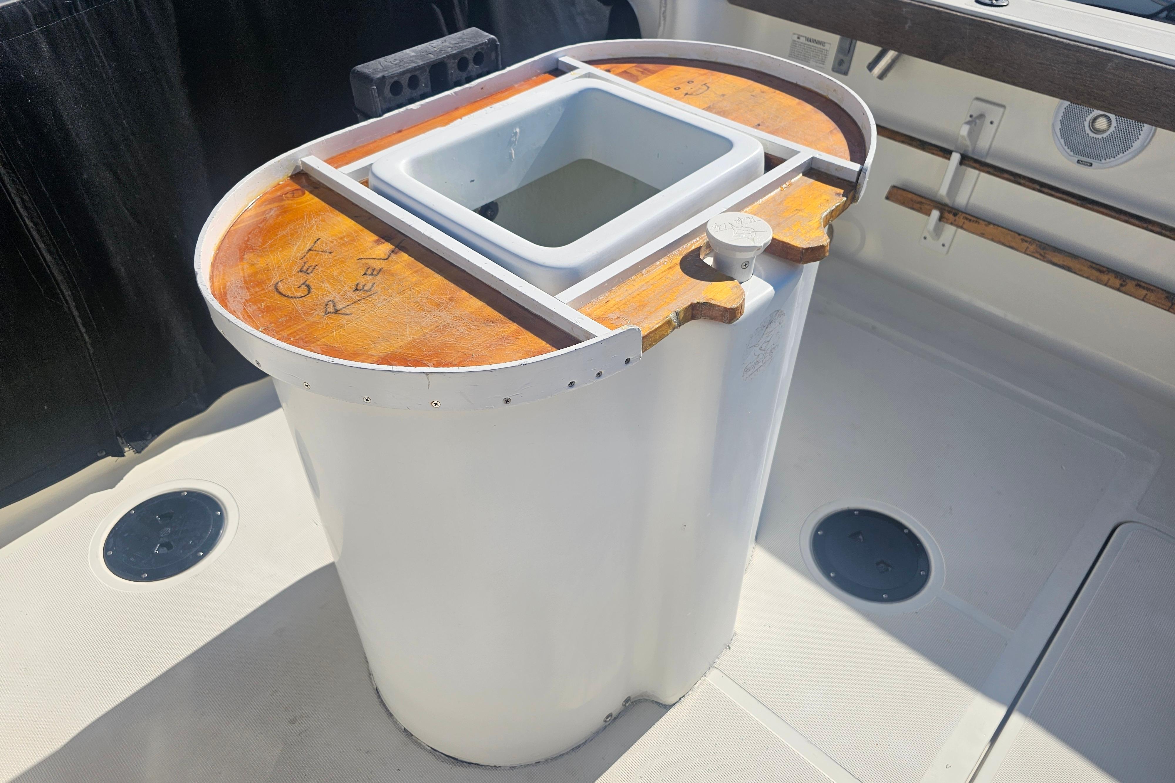 2001 Pursuit 3000 Express boat with a custom fishing station on deck.