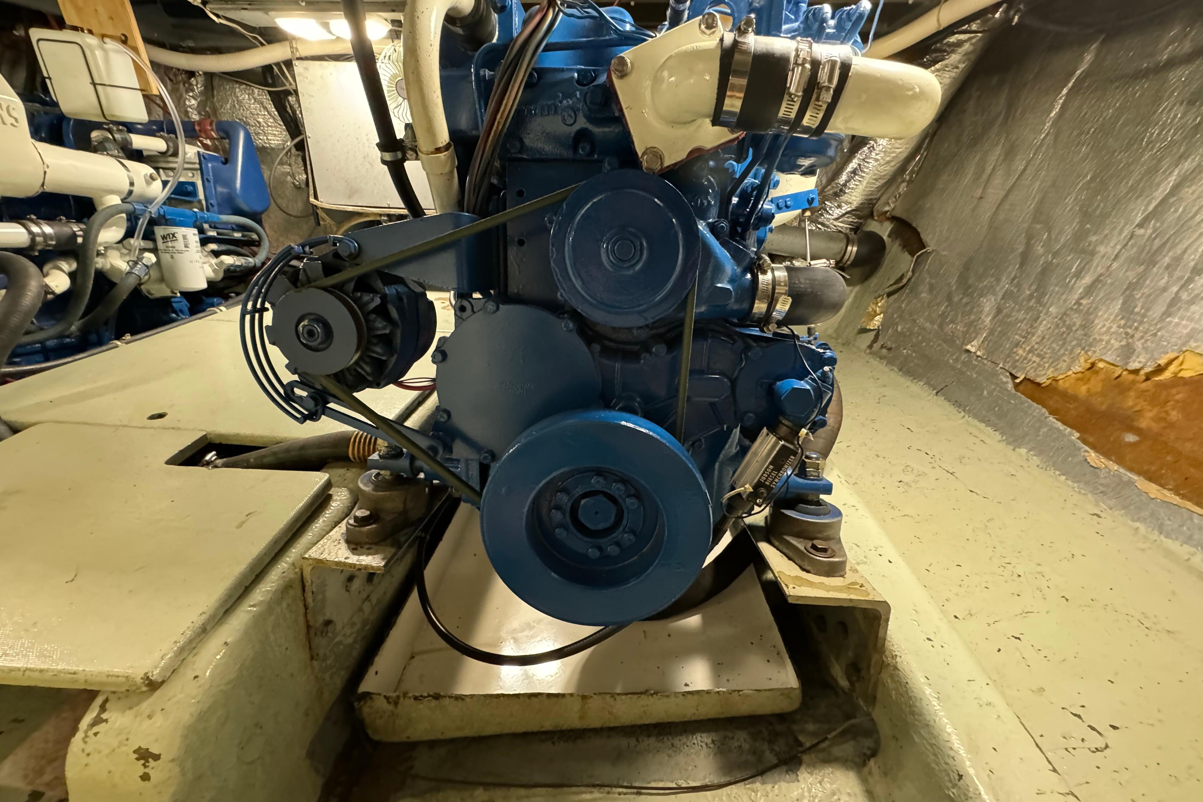 Engine room of a 1978 Californian 42 LRC boat, featuring a blue marine engine.