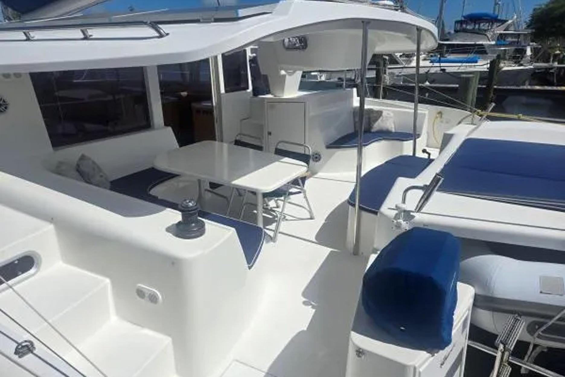 2008 Fountaine Pajot Salina 48 catamaran with spacious deck and seating area in marina.