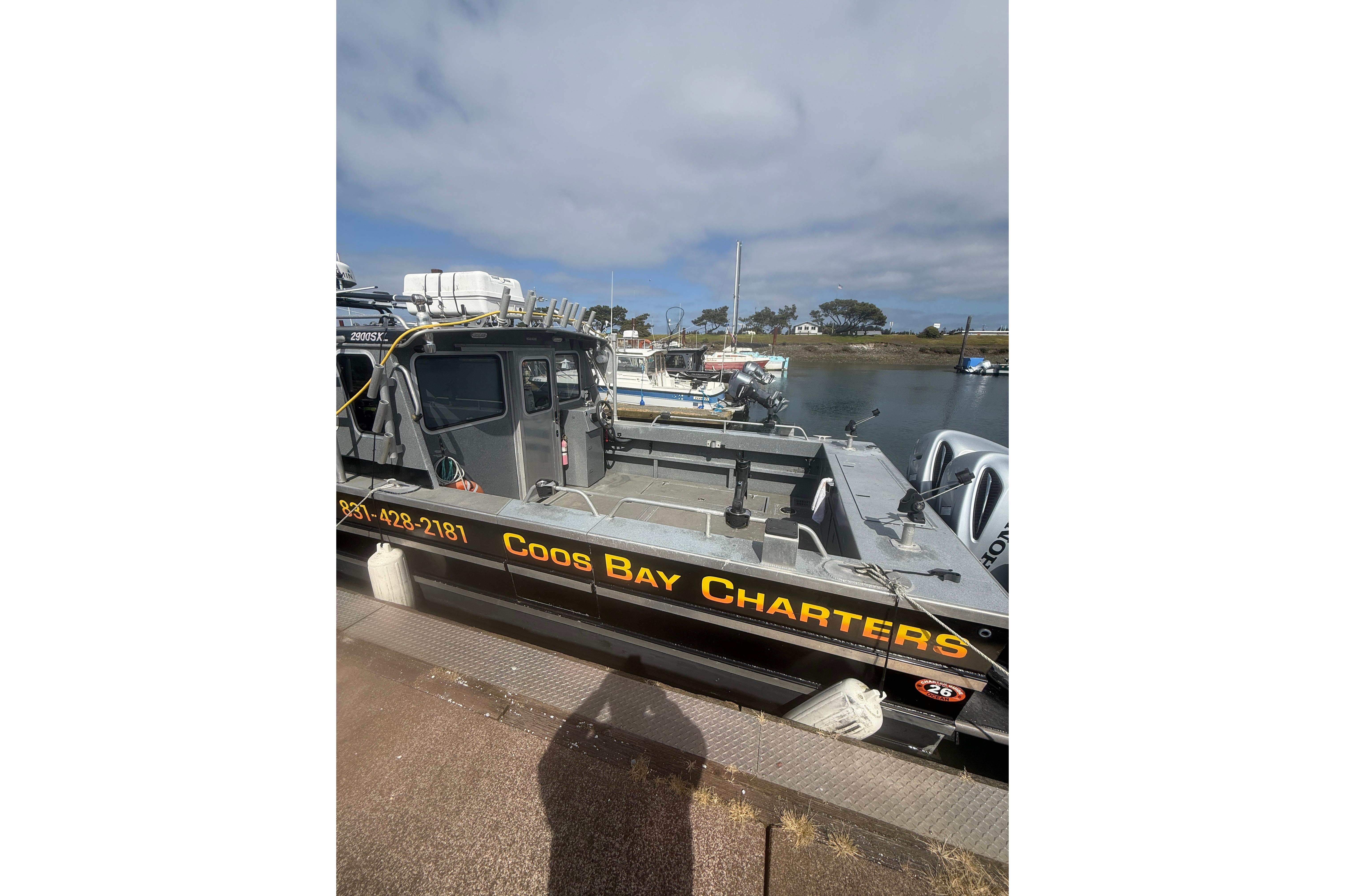 2016 North River 29 Offshore boat docked, featuring "Coos Bay Charters" signage.