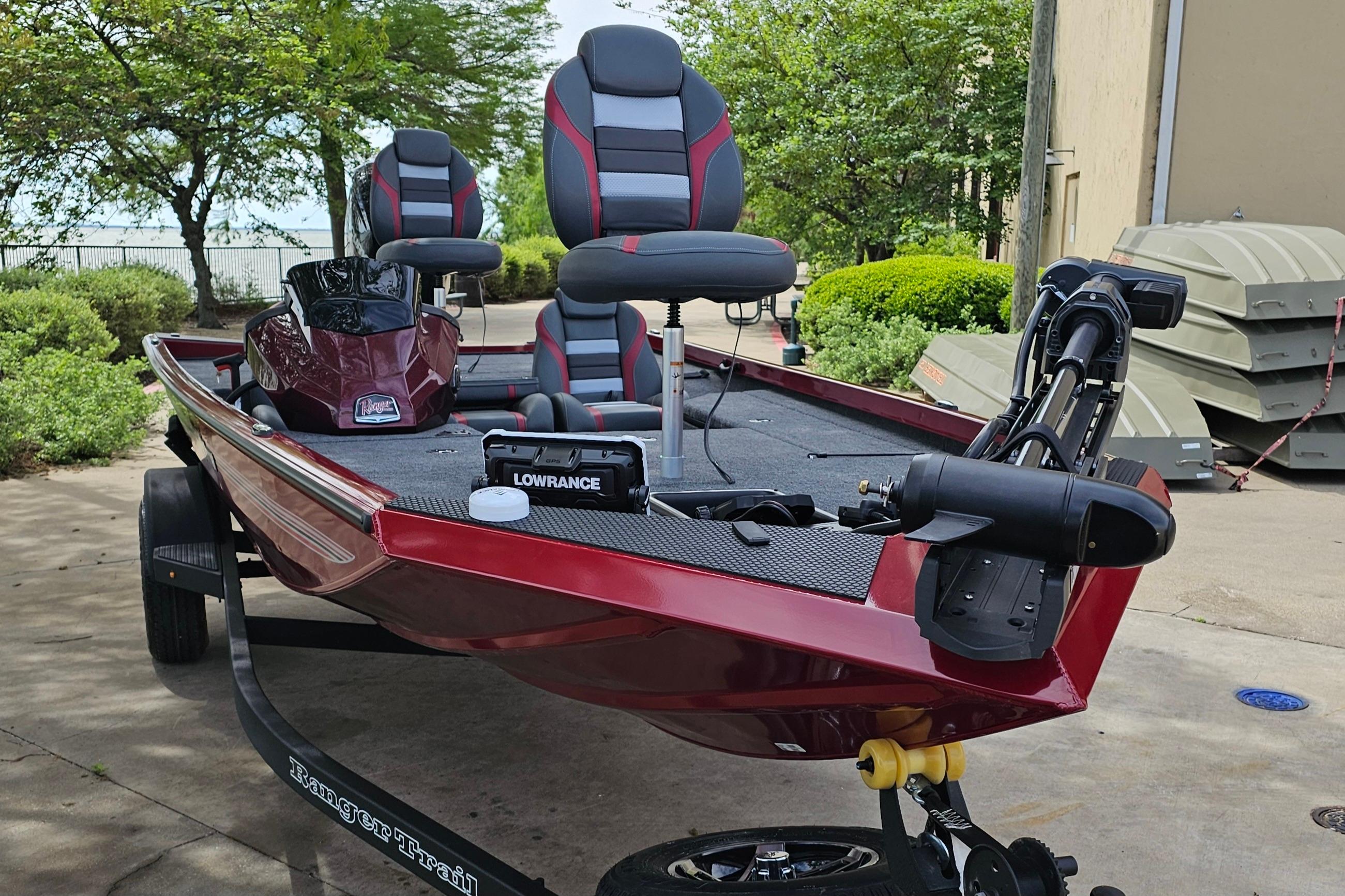 2026 Ranger RT178 boat with red and gray seating, parked outdoors.