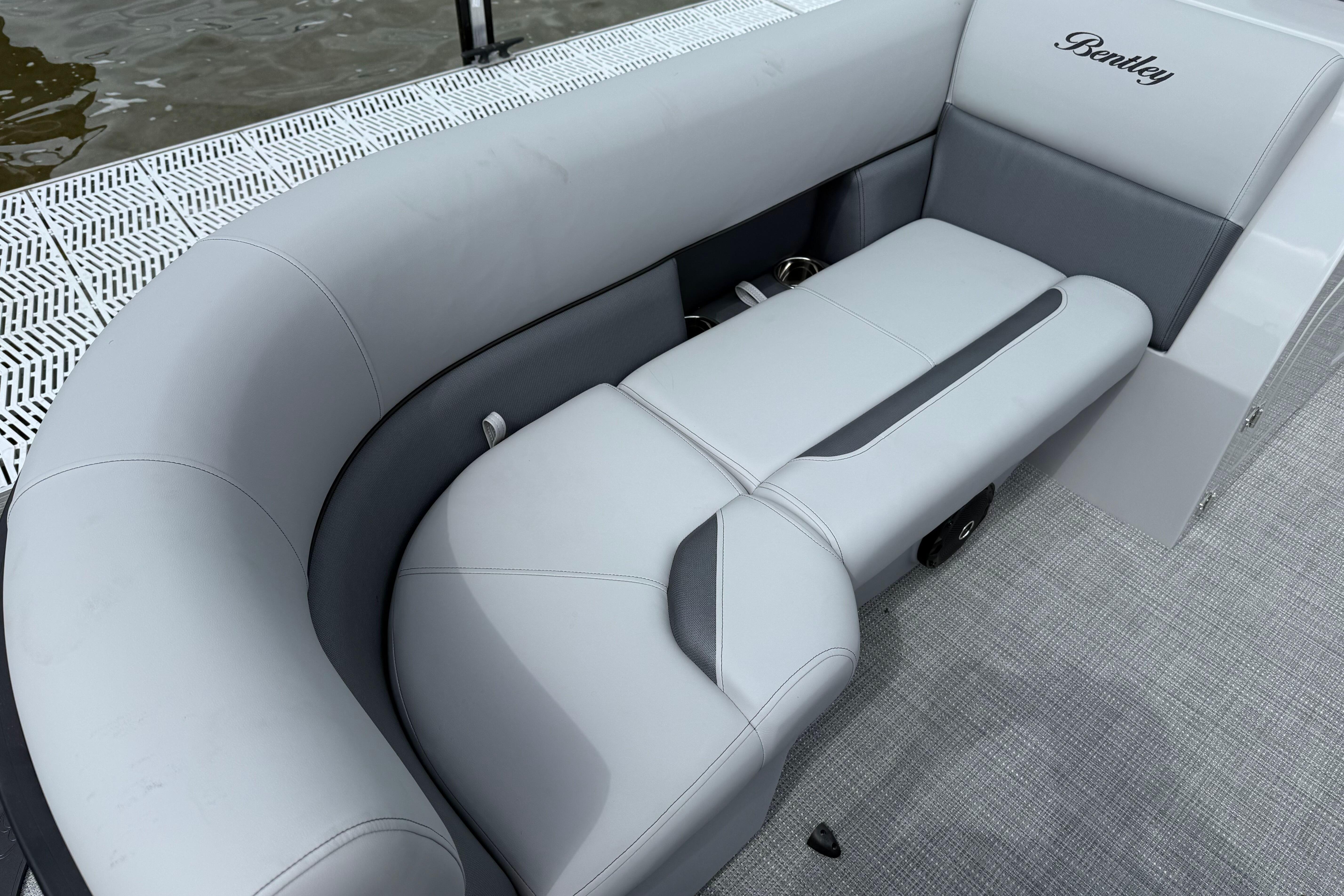 Luxurious seating on 2026 Bentley Pontoons Legacy 220 Navigator, featuring elegant gray upholstery.