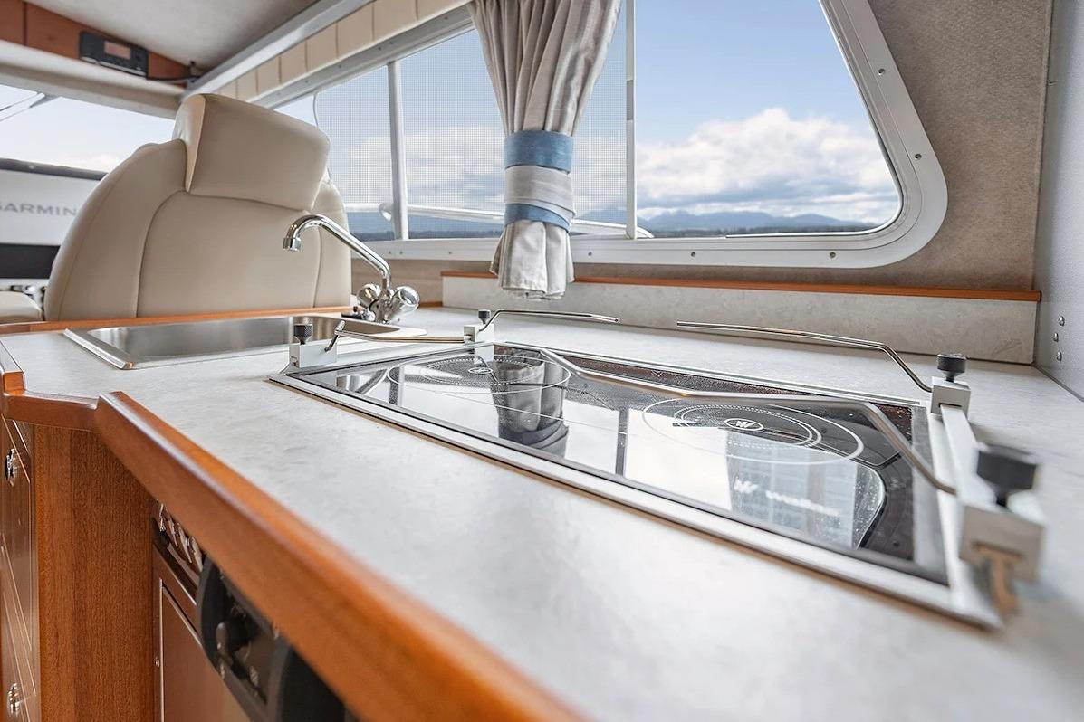 Interior of 2026 KingFisher 3225 GFX Offshore boat with modern kitchen amenities.