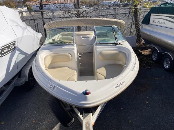 2001 Sea Ray 180 Bow Rider boat with beige interior, parked on a trailer.