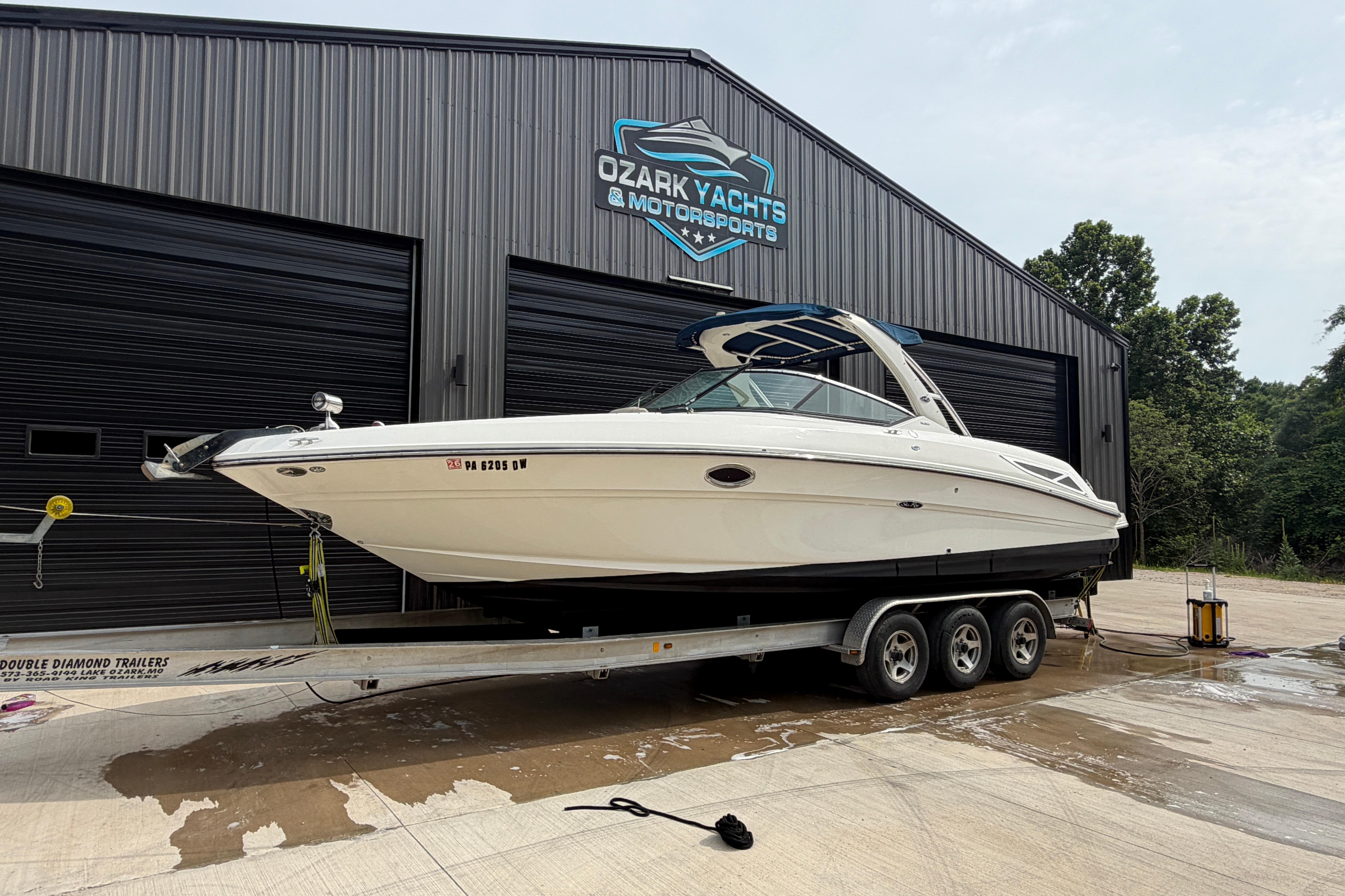 2013 Sea Ray 300 SLX boat on trailer at Ozark Yachts facility.