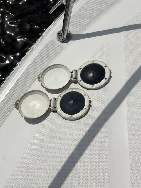 Close-up of two round deck hatches on a boat.